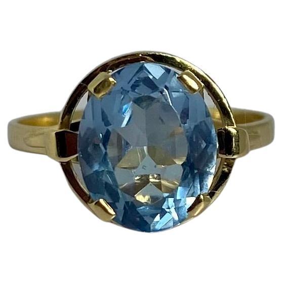 Bague d'occasion en or jaune 18 carats avec un spinelle rond à facettes bleues