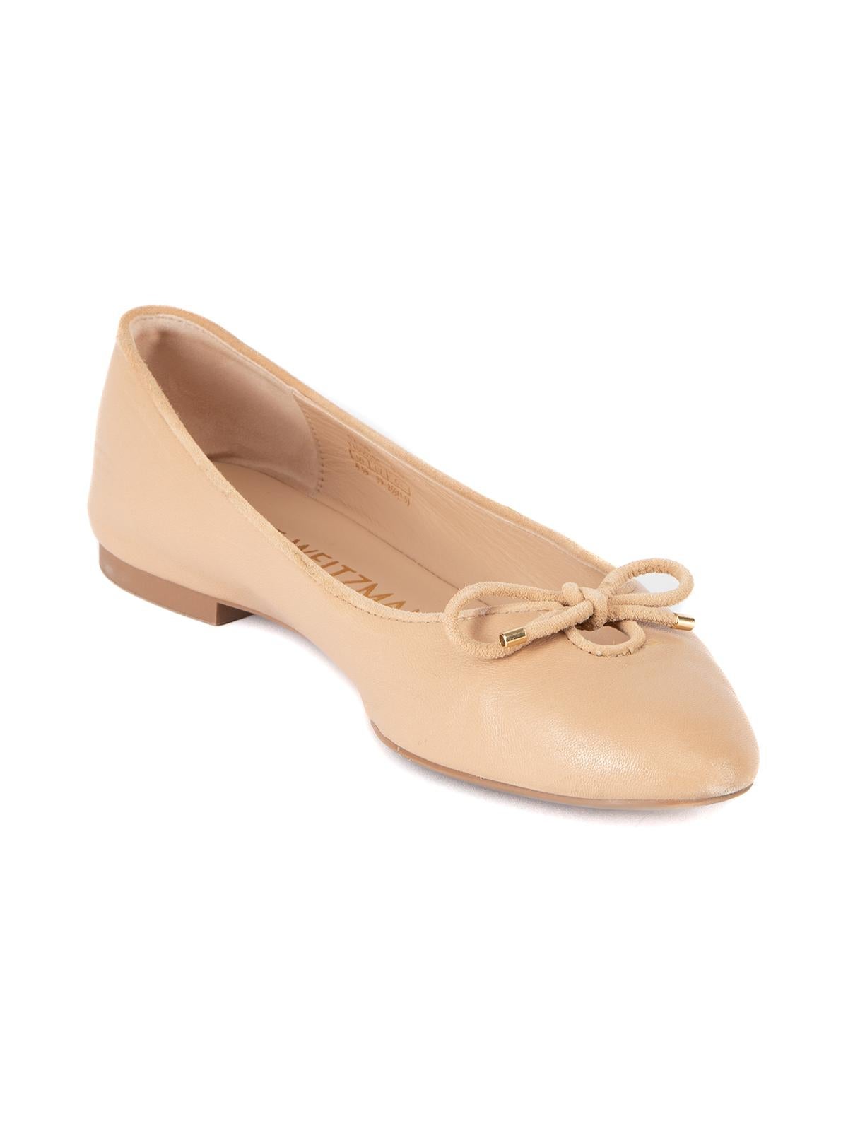 CONDITION is Very good. Minimal wear to shoes is evident. Minimal wear to suede trim with some light scuffs on this used Stuart Weitzman designer resale item. Details Nude Leather Ballerina flats Almond toe String accessory, gold tone caps Comes