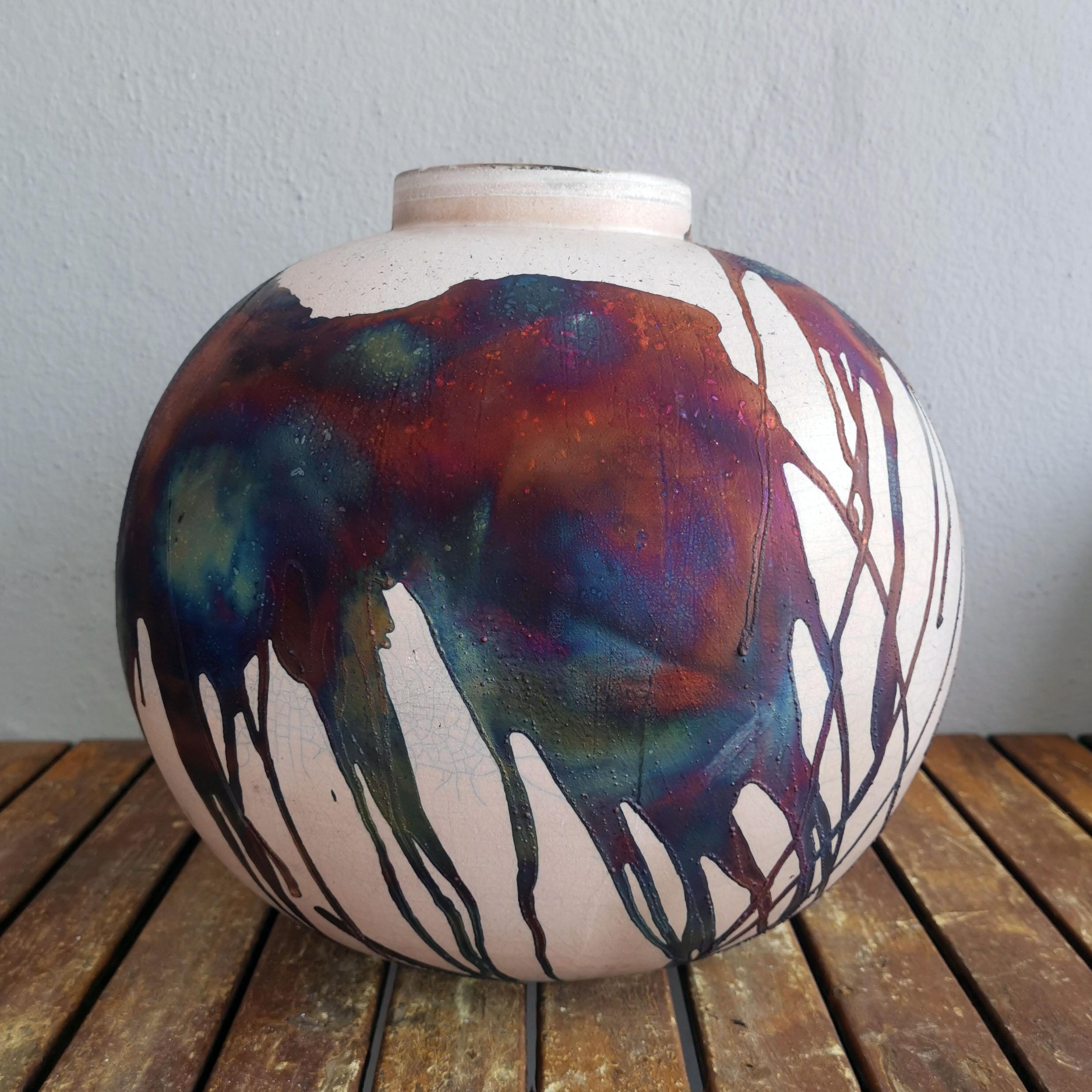 THIS IS A PRE-ORDER

A mesmerizing sight to behold as soon as the rainbow-like patinas catch your eye. This Globe XL Vase is a round, capacious piece produced using the Raku technique, resulting in a beautiful unpredictable finish. This vase would