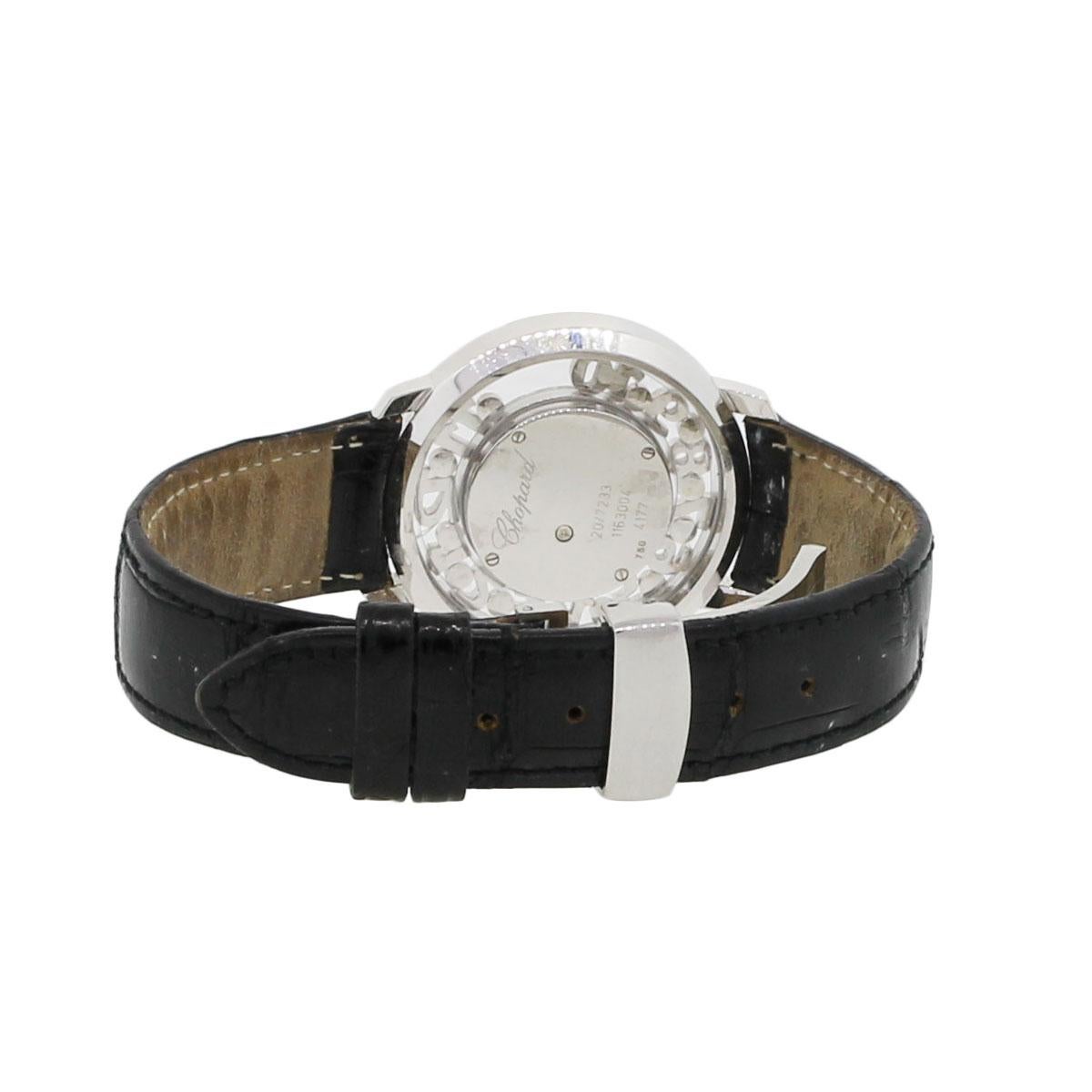 Brand: Chopard
Model: Happy Diamonds
Item #: 20/7233
Case Material: 18K White Gold
Case Diameter: 39mm
Bracelet: Black Leather
Dial: Mother of Pearl
Bezel: 12 Floating Numbers and 12 Floating Diamonds
Crystal: Scratch Resistant Sapphire
Size: