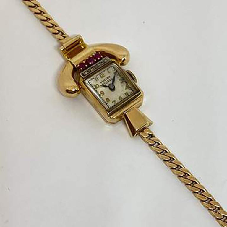  Estate diamond & ruby Lucien Picard vintage timepiece in 14 karat yellow gold. Mechanical 17 jewel movement in working order. Single cut diamonds and round faceted rubies. The case measures 18 x 14mm. The watch is approximately form 1940's. No