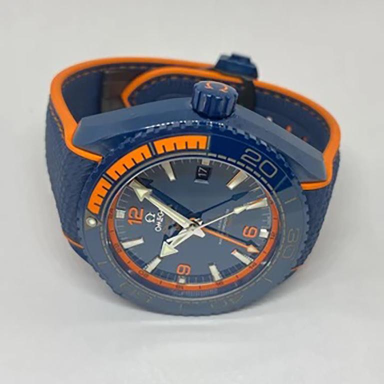Men's luxury limited-edition Omega Seamaster Planet Ocean Big Blue watch designed in blue ceramic steel with blue and orange rubber strap. Excellent condition and comes with original box, booklet, hangtag, and card. Year: 2016. Last Known Retail: