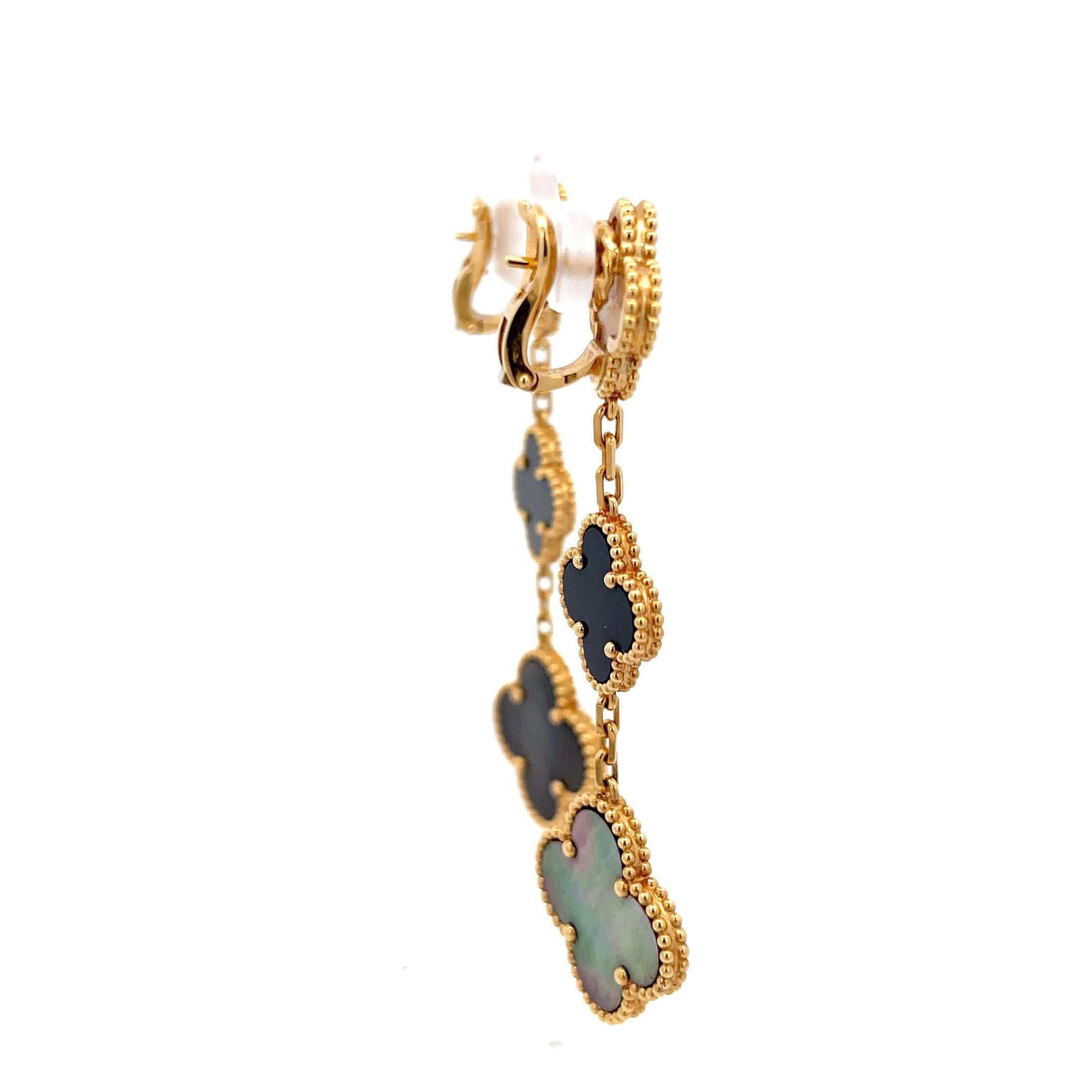 Pre-owned Van Cleef & Arpels Magic Alhambra Earrings in 18K Yellow Gold. The earrings feature three motifs of onyx and  gray and white mother-of-pearl  on each earrings. The earrings are 2.75