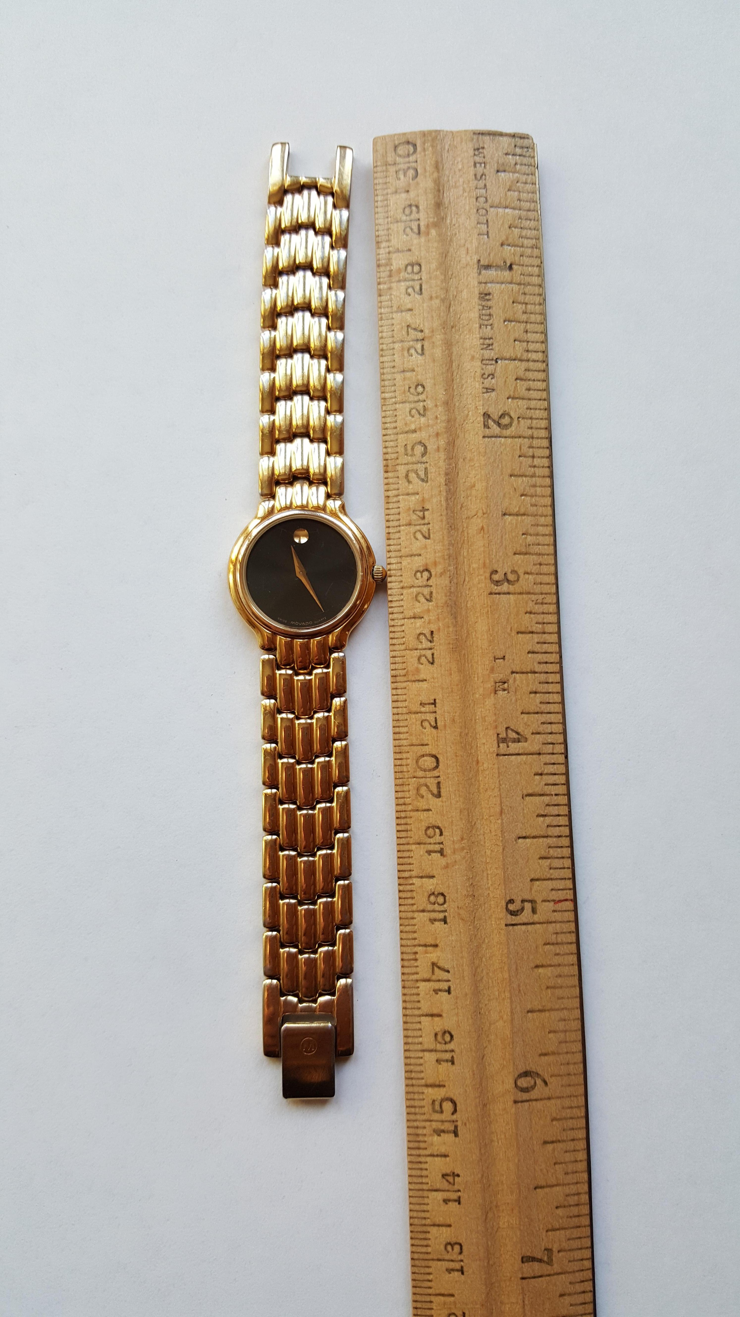 movado women's gold watch with black face
