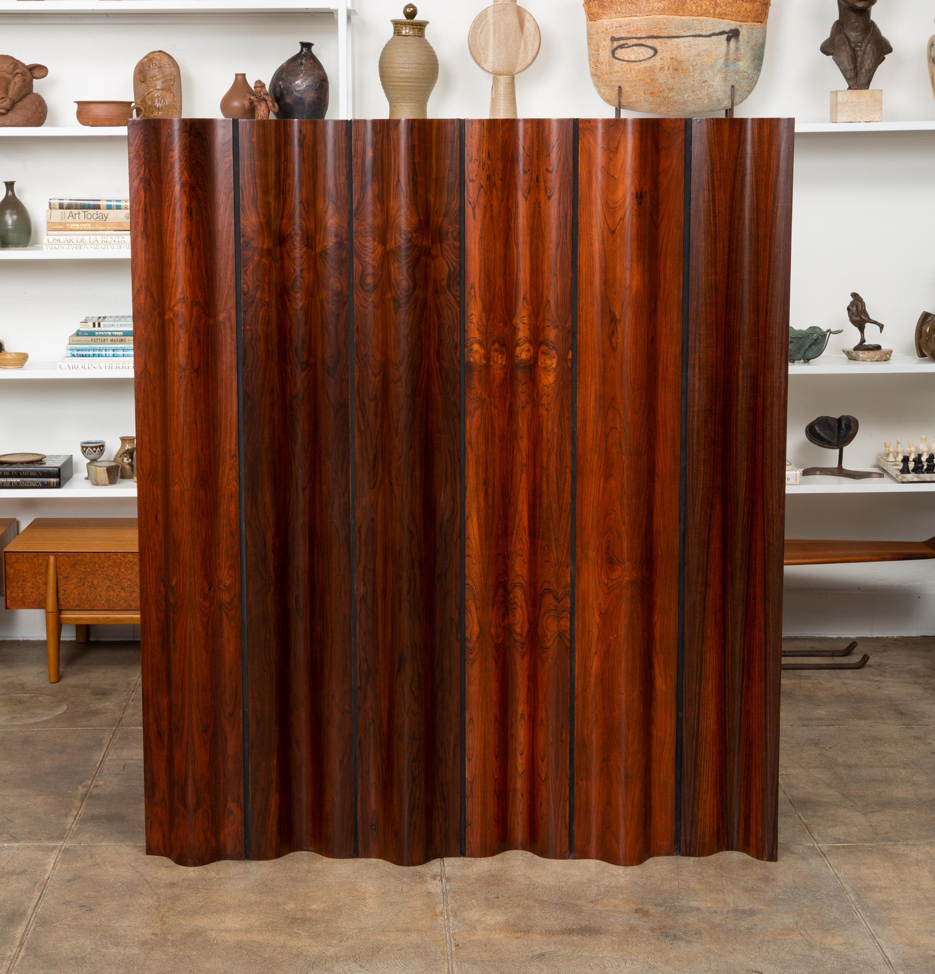 Ray and Charles Eames iconic folding screen for Herman Miller, in rosewood. When the harvesting of Brazilian rosewood became illegal in 1992, Herman Miller ceased purchasing it for their Eames lounge chairs. They took their remaining rosewood stock