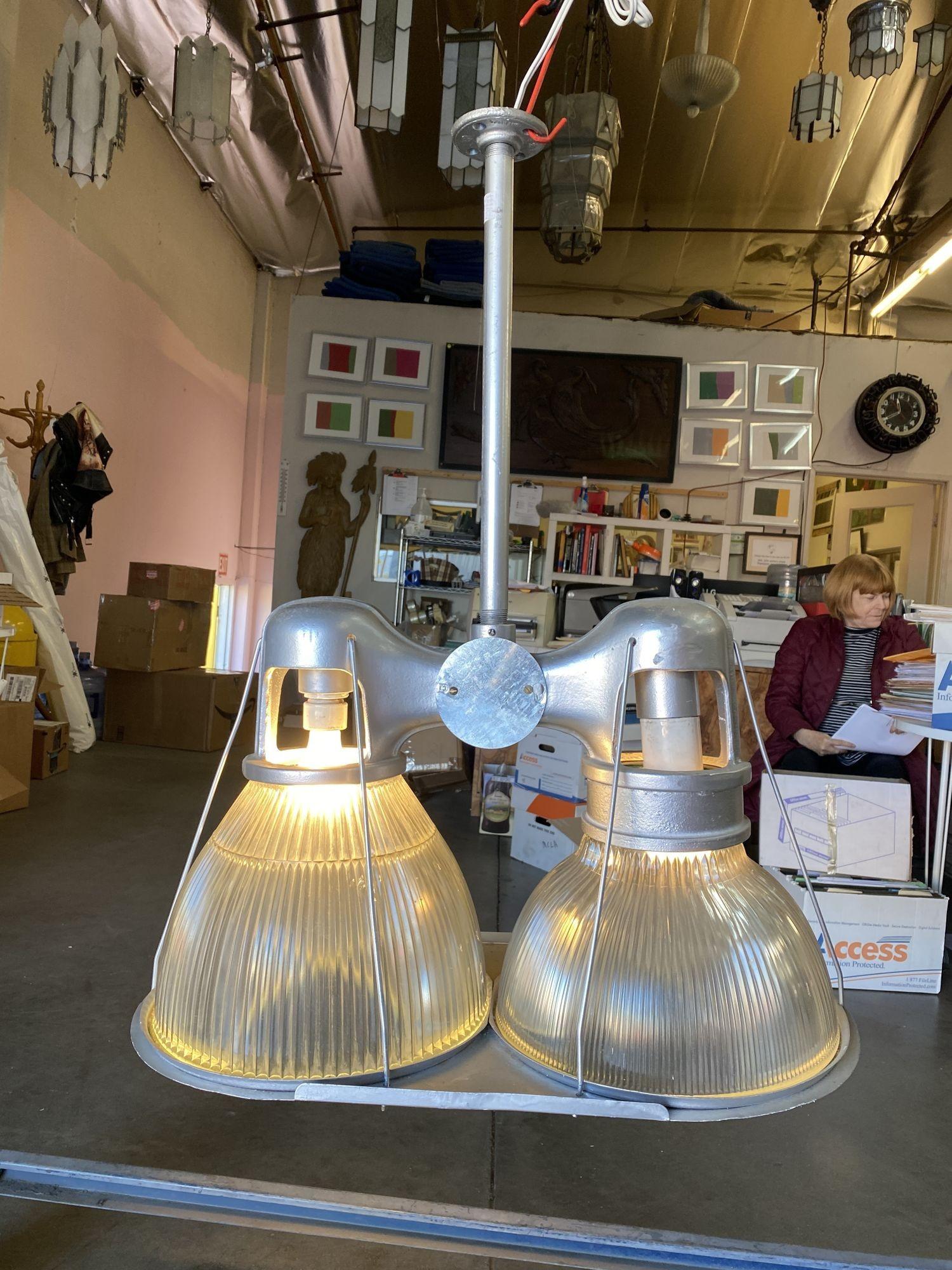 Produced by Holophane, the preeminent name in commercial lighting since 1898, this 1940s-era Asymmetric double fixture has recently been inspected and rewired. It uniquely fixture features a company-made body that takes two different size shades