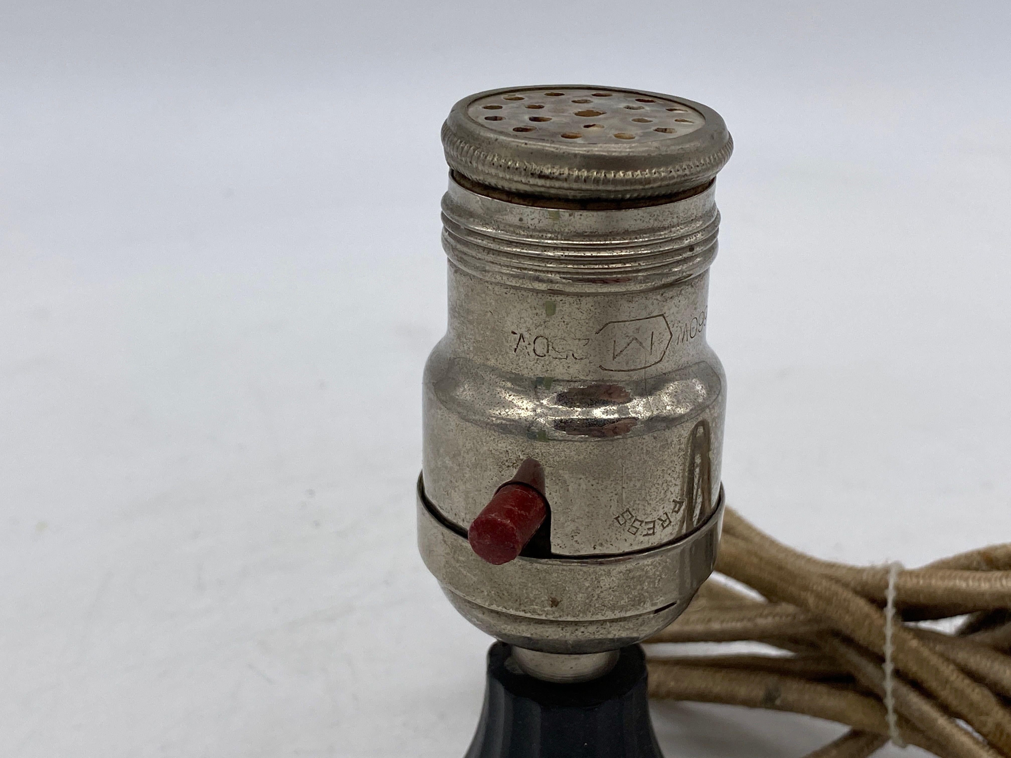 Pre-War electric lamp base lighter, featuring a modified lamp socket fixed with an electric lighter similar to car light.

Circa 1930.