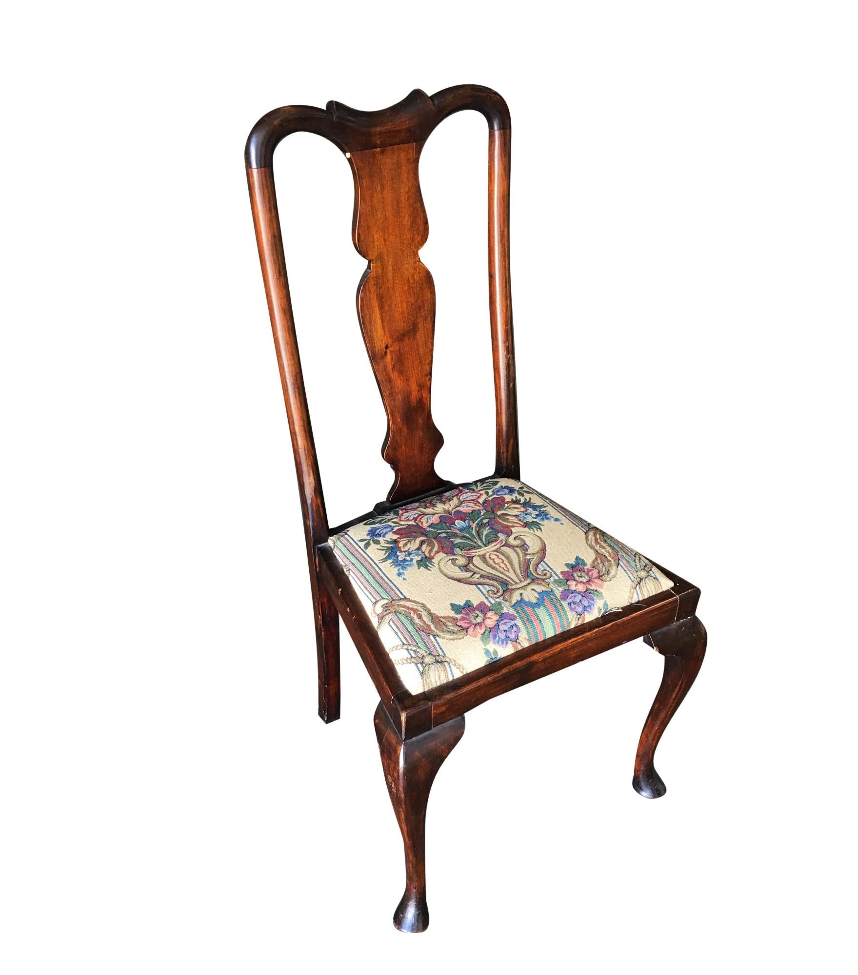 Set of four mahogany Art Deco era dining room chairs, each with petite sculpted seat back and tapestry style seat covers. Circa 1940. These chairs have some scratches on the wooden frames, which we can refinish before shipping out.

Dimensions: