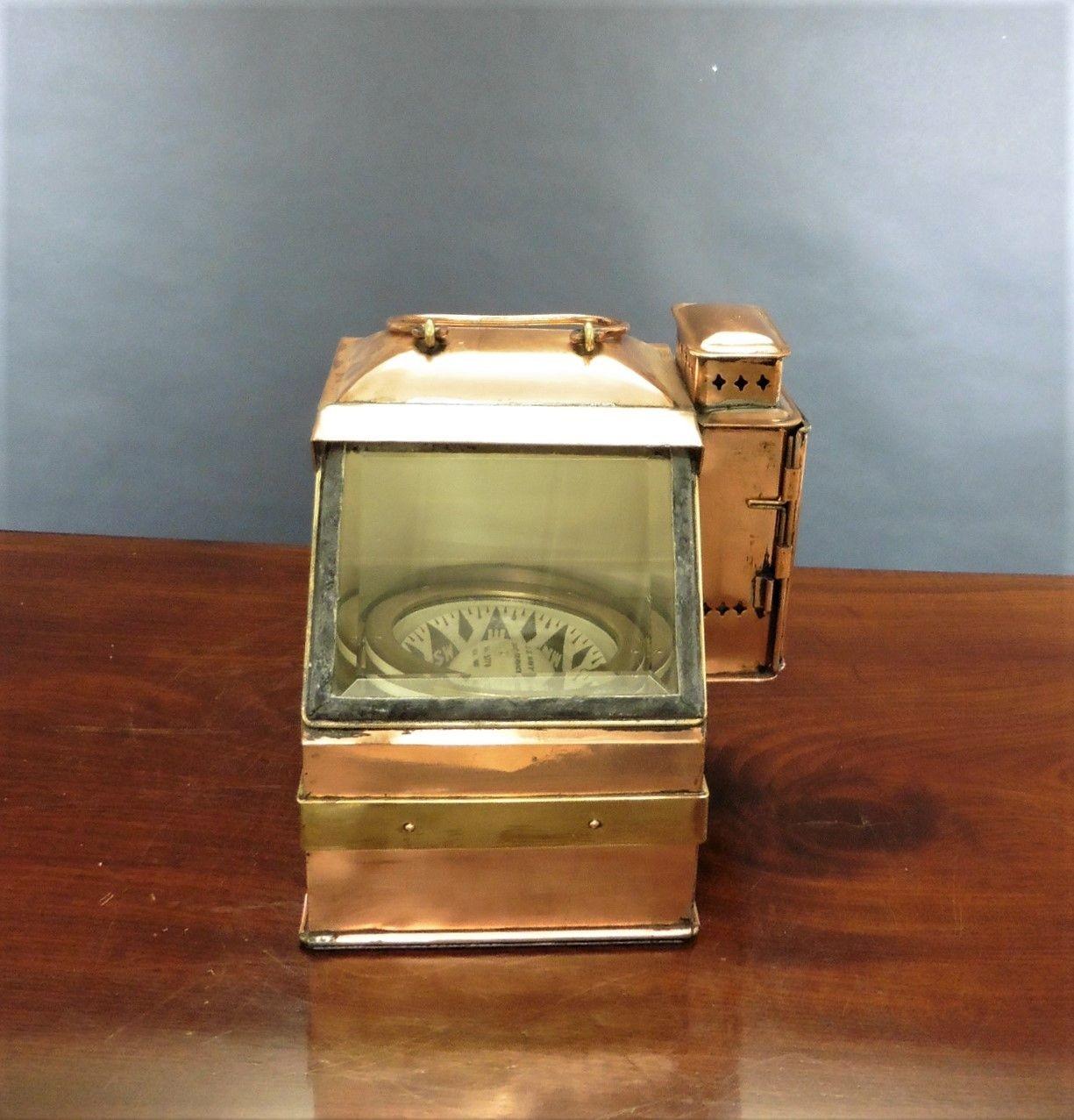 Pre World War I Nautical Compass by E.S.Ritchie
 
Nautical compass mounted by a brass gimbal into a copper brass bound case with sloping glazed aperture with heavily bevelled glass. Flat brass bezel with five holding screws signed ‘E.S.Ritchie’ and
