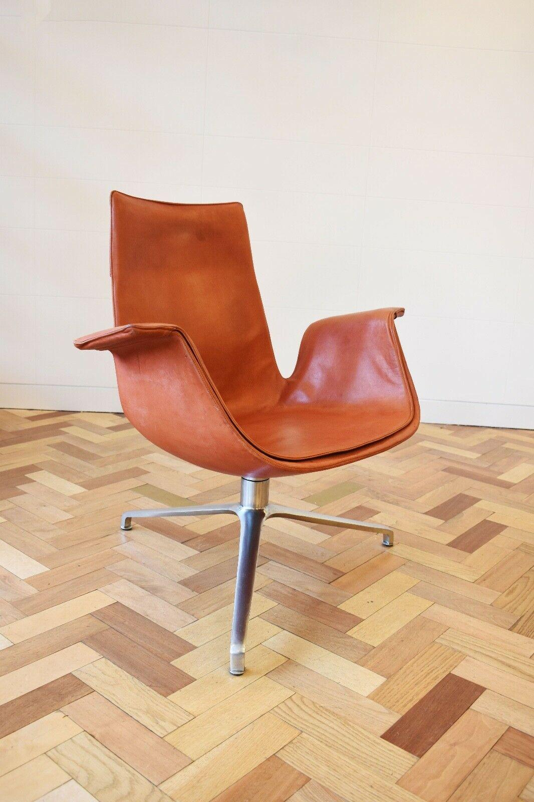A vintage Tulip chair model ' FK6725' designed by Preben Fabricius and Jorgen Kastholm & made by Alfred Kill International in its original tan leather, 1970's set on an aluminium swivel base.
Preben Fabricius and Jorgen Kastholm are both Danish