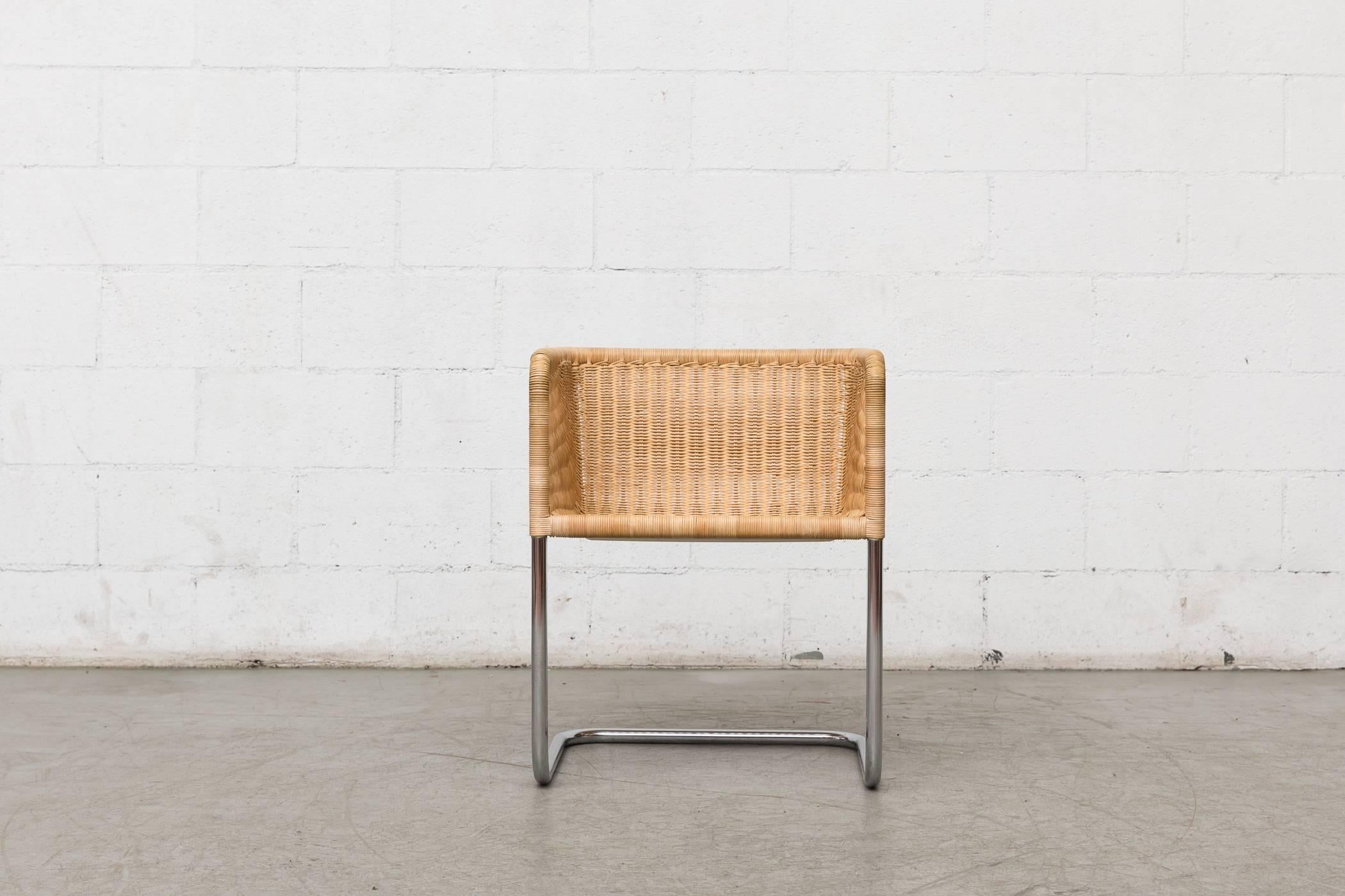 Cantilevered woven rattan chair designed by Preben Fabricius & Jorgen Kastholm. Wicker bucket seat on a cantilevered chrome frame. Original condition.
