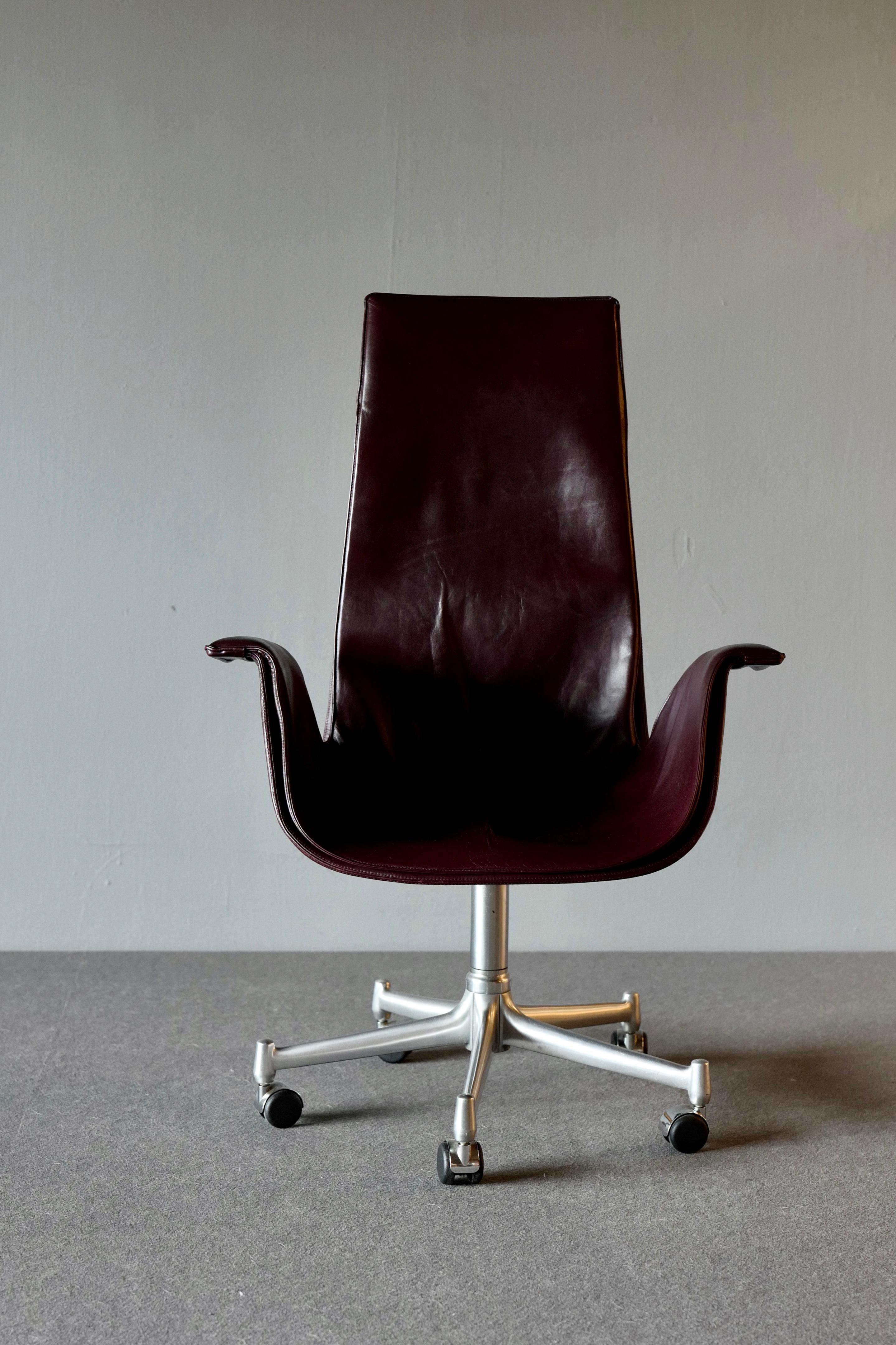Office chair by Preben Fabricus and Jorgen Kastholm for Kill International. This “Bird” chair or “Tulip” chair is a gorgeous bucket armchair fabricated from a fiberglass shell encased in well patinated brown leather. It has a 5 star central foot in
