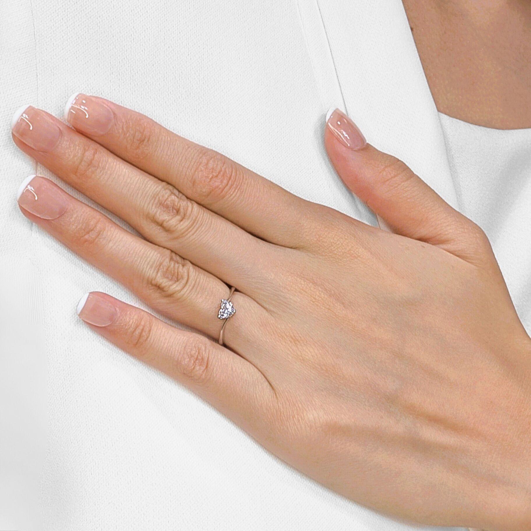 Declare your love with this romantic ring, showcasing a captivating heart-shaped natural diamond in a stunning solitaire setting with a delicate twist band, all crafted in radiant 18K white gold. At its center, a breathtaking 0.50ct natural