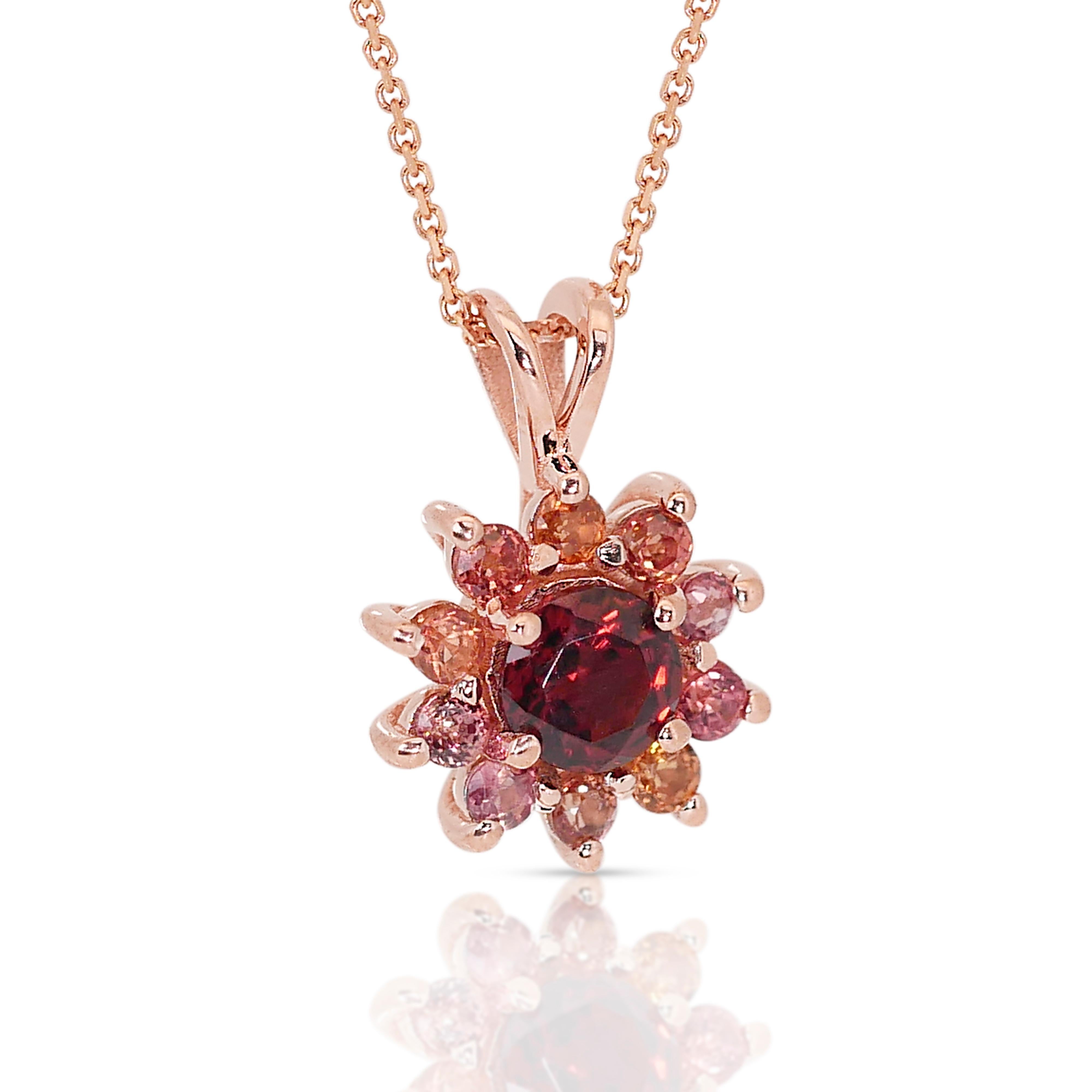 This exquisite and one of a kind necklace is meticulously crafted in 18K rose gold, adorned with a captivating garnet gemstone. Surrounding the garnet are a cascade of dazzling sapphires, each one meticulously chosen for its exceptional brilliance