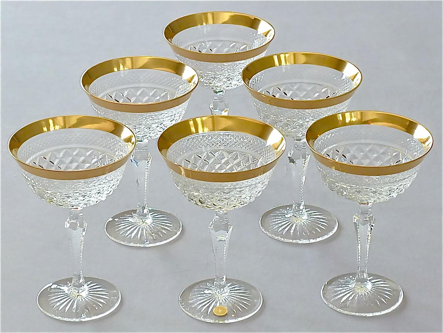 Gorgeous 20th century handcrafted faceted crystal glass set with 24 carat gold rim made by Josephinenhütte Moser circa 1960-1970 and very in the style of the exclusive french company Baccarat or Saint Louis thistle. This exquisite set of 6 champagne
