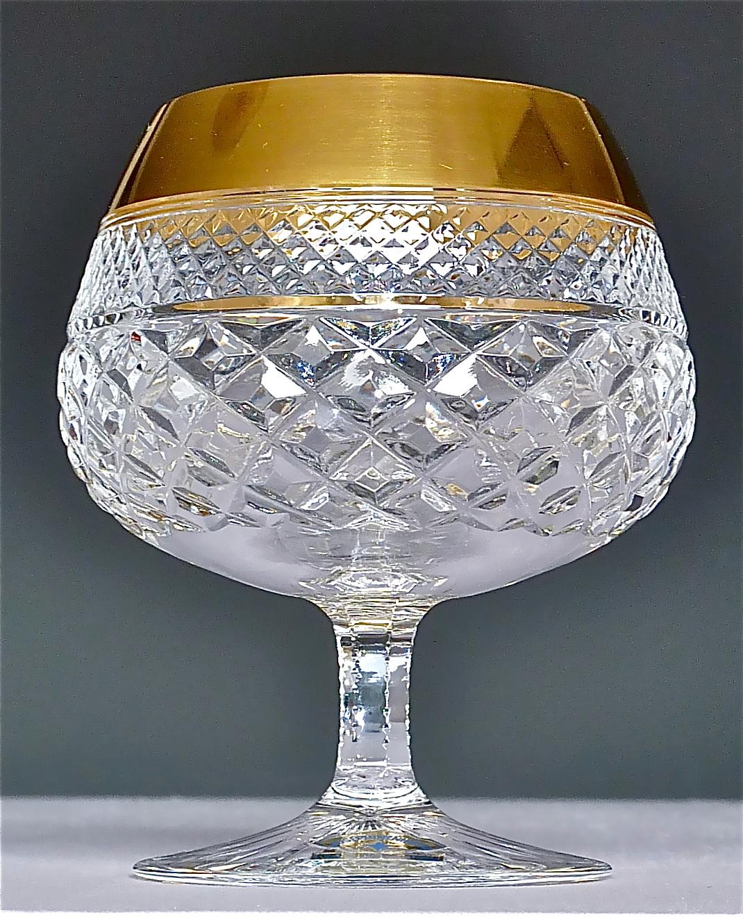 Gorgeous 20th century handcrafted faceted crystal glass set with 24-carat gold rim made by Josephinenhütte Moser circa 1960-1970 and very in the style of the exclusive French company Baccarat or Saint Louis thistle. This exquisite set of 6 cognac