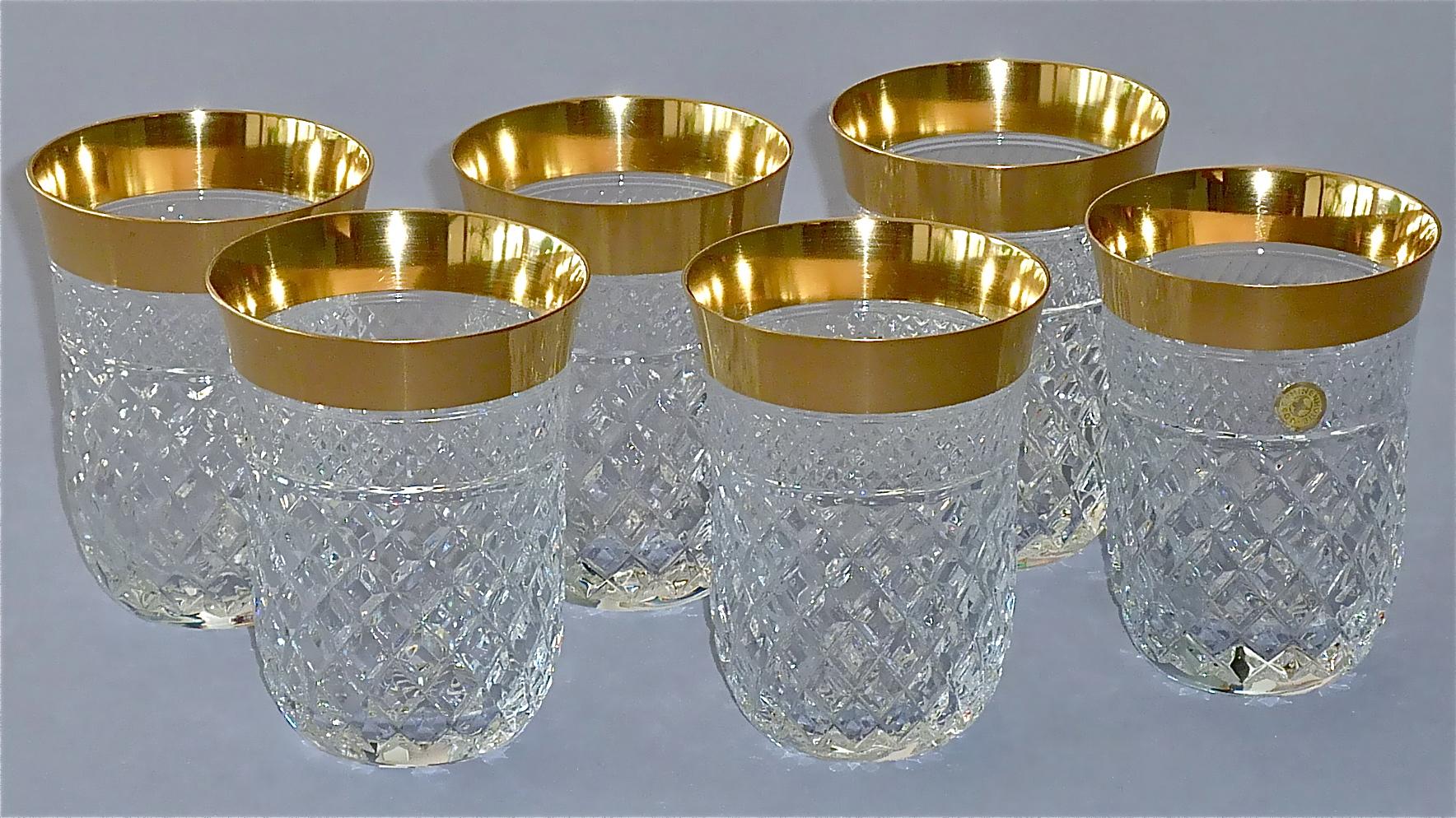 Gorgeous 20th century handcrafted faceted crystal glass set with 24-carat gold rim made by Josephinenhütte Moser circa 1960-1970 and very in the style of the exclusive French company Baccarat or Saint Louis thistle. This exquisite set of 6 water