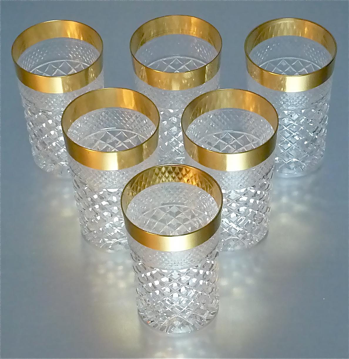 Gorgeous 20th century handcrafted faceted crystal glass set with 24-carat gold rim made by Josephinenhuette Moser circa 1960-1970 and very in the style of the exclusive French company Baccarat or Saint Louis thistle. This exquisite set of 6 water