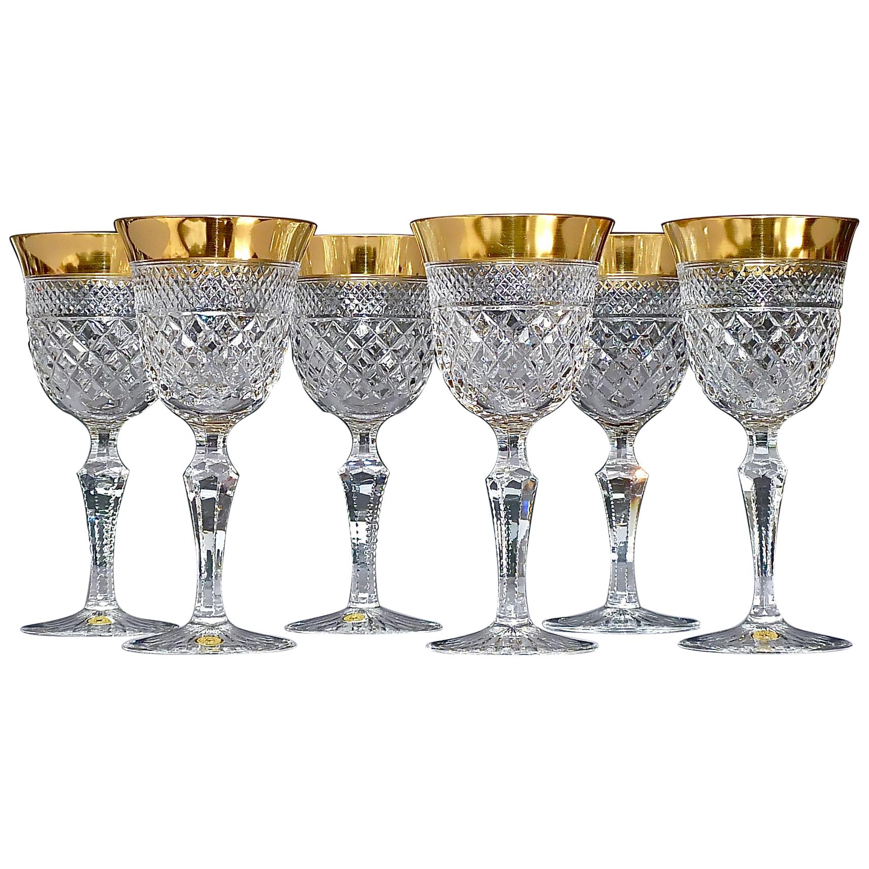 Gorgeous 20th century handcrafted faceted crystal glass set with 24 carat gold rim made by Josephinenhütte Moser circa 1960-1970 and very in the style of the exclusive French company Baccarat or Saint Louis thistle. This exquisite set of 6 white