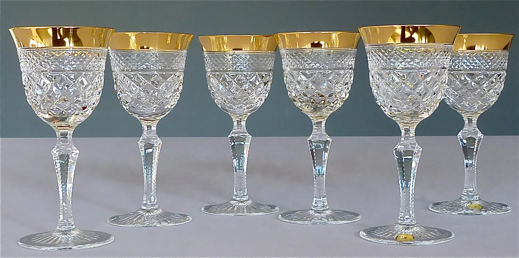 Gorgeous 20th century handcrafted faceted crystal glass set with 24-carat gold rim made by Josephinenhütte Moser circa 1960-1970 and very in the style of the exclusive French company Baccarat or Saint Louis thistle. This exquisite set of 6 wine