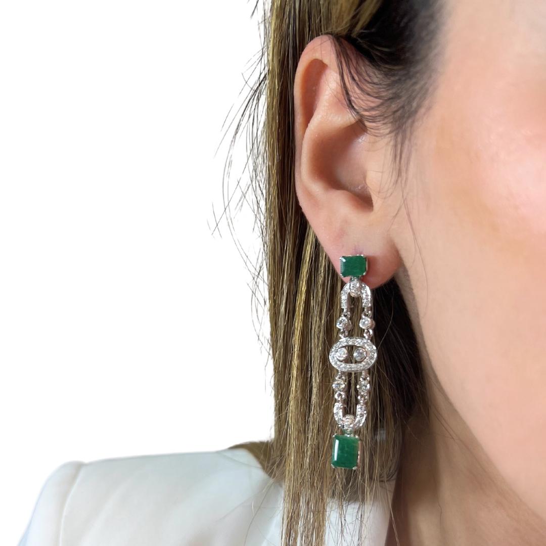 Precious 8.45ct Emeralds and Diamonds Drop Earrings in 14k White Gold - IGI Certified

Make a statement with these breathtaking 14k white gold drop earrings, featuring four exquisite emerald-cut emeralds totaling 7.00ct. Their rich green hue is