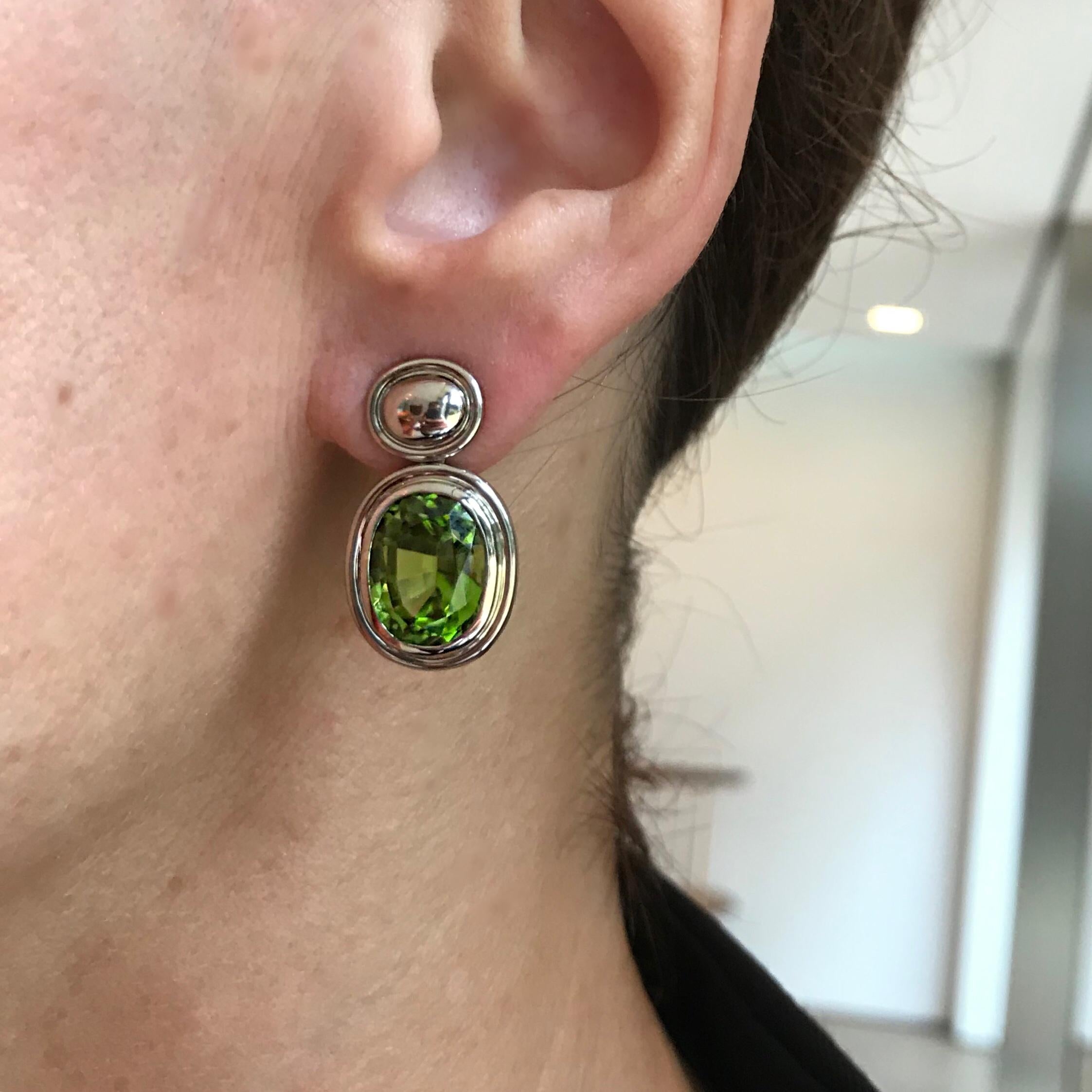 These earrings from Colleen B. Rosenblat's Precious Basics collection are handcrafted in an 18 carat white gold timeless and sophisticated setting, the two vivid green peridots of 13.55 ct are providing a showstopping and elegant look.  