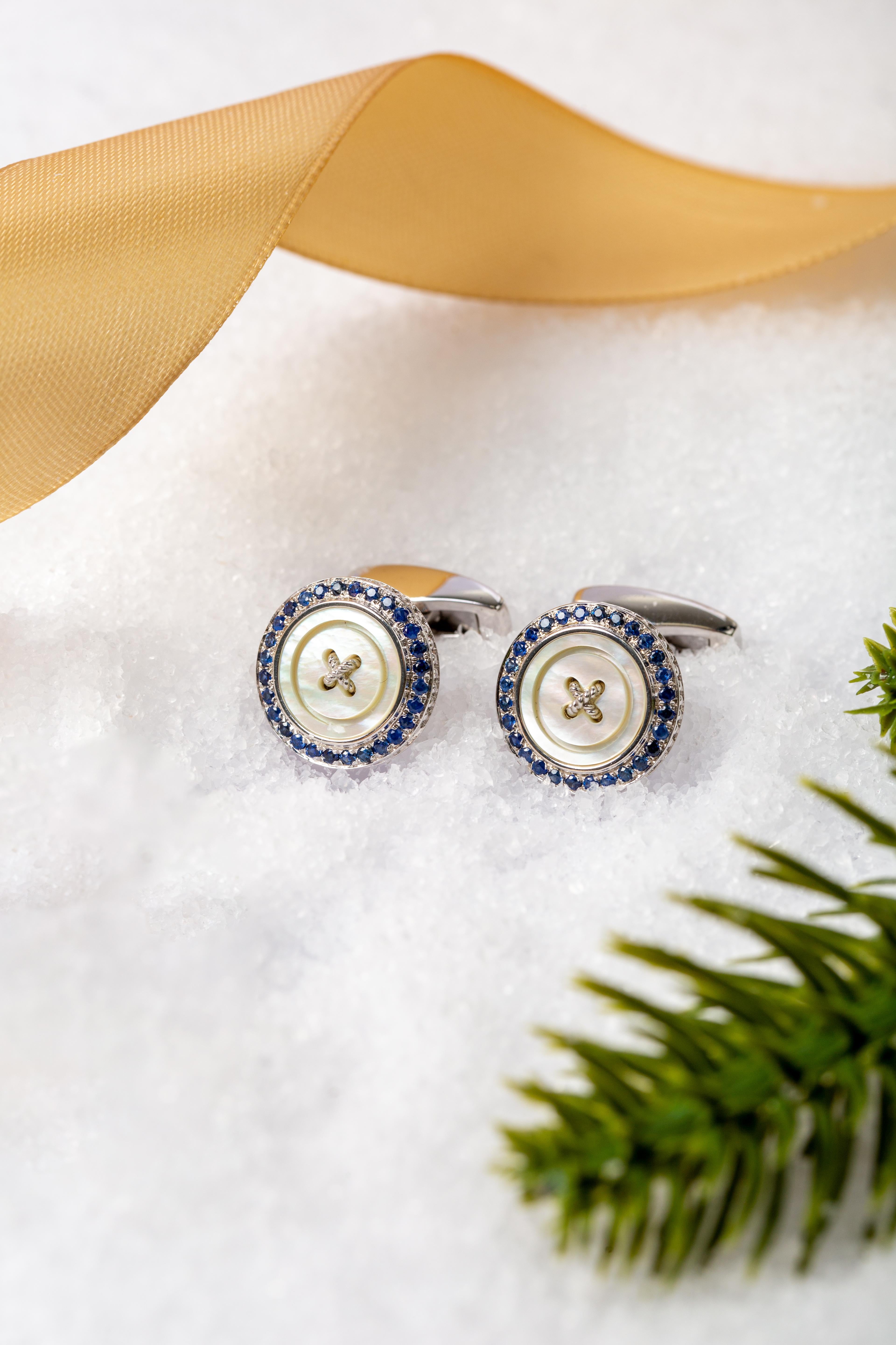 Precious Button Cufflinks with White Mother of Pearl & Sapphires

A luxurious reinvention of the classic tailoring button. This button is meticulously crafted from three materials, silver, semi-precious stone and precious rubies or sapphires. The