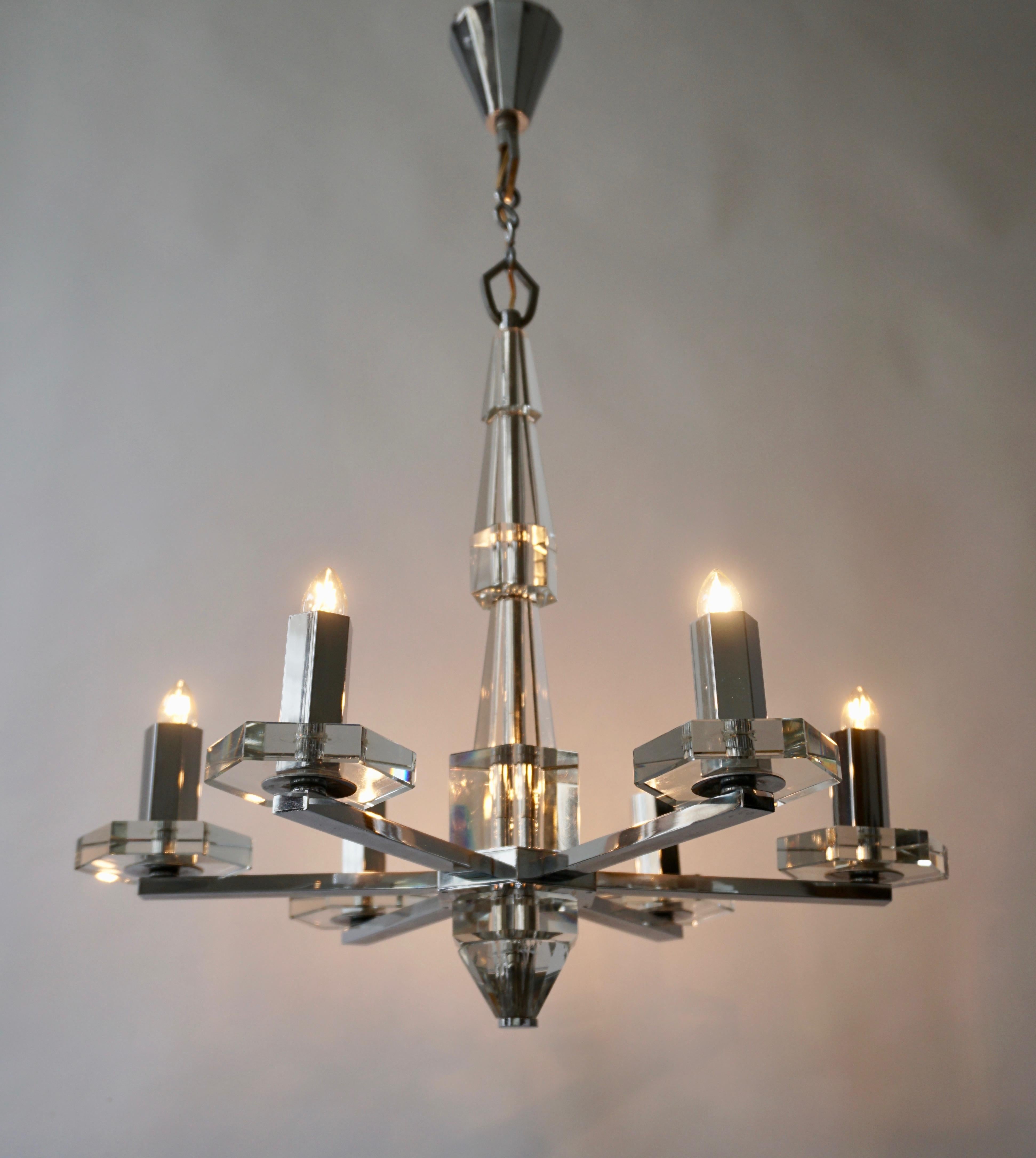Precious faceted crystal glass Art Deco chandelier. The beautiful chandelier takes six E14 standard screw bulbs to illuminate. The wiring is very good so it is in fine working order and ready to use. The total length is about 70 cm, and it has a