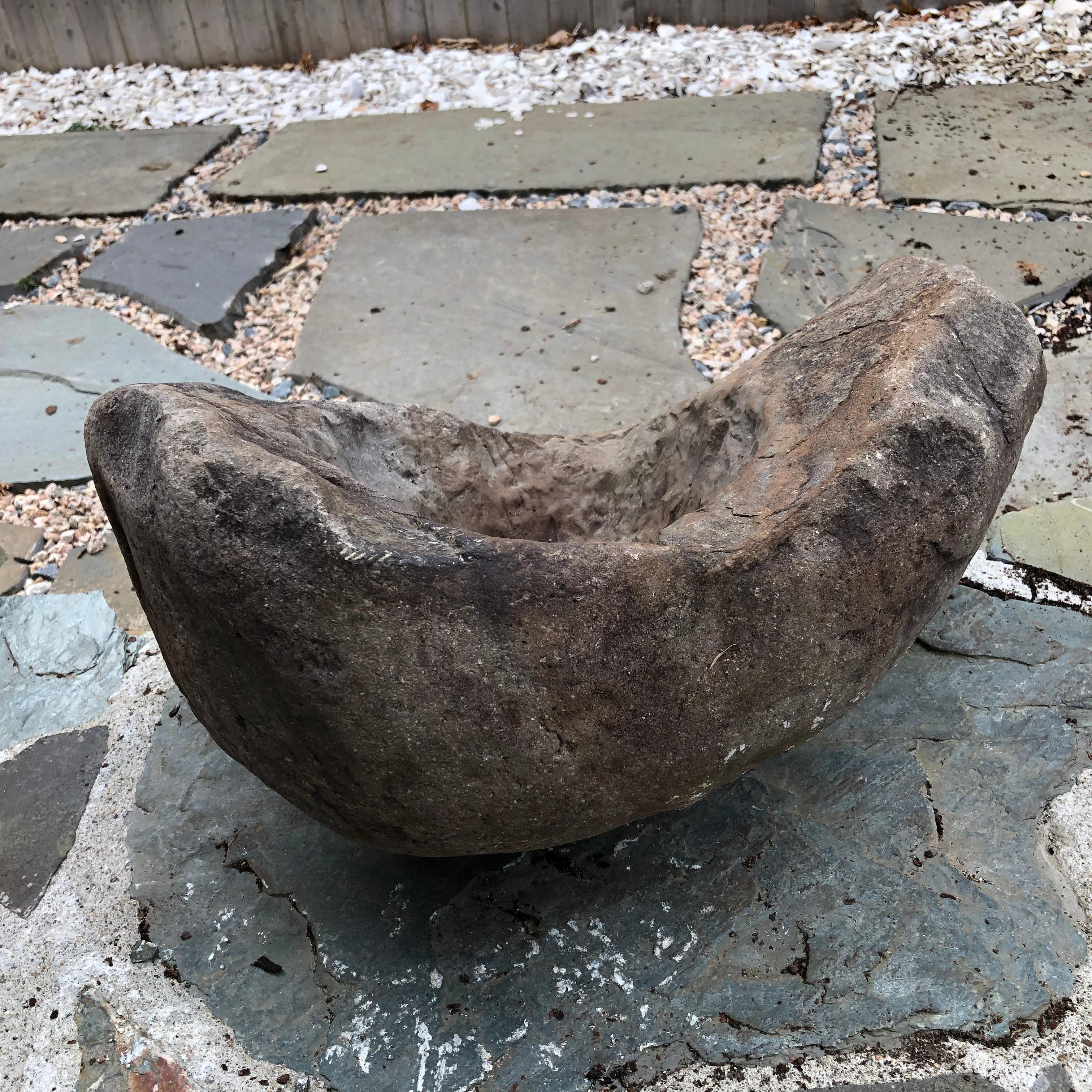 Japan, a handsome and unique antique natural organic shaped cradle shaped stone water basin planter -tsukubai- created from rare dark hard stone and sourced from a decades old garden. This is a unique and visually attractive garden planter or water