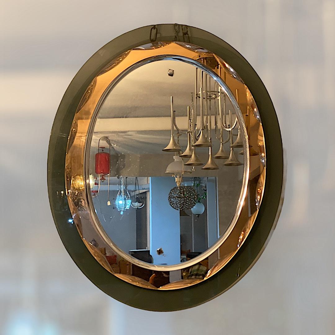 Beautiful mirror attributed to Max Ingrand for Fontana Arte. The mirror is in peach and green colored faceted glass framed. 
 Available an other very similar mirror in peach and amber glass frame of the same  size. 
It is a reflection of something