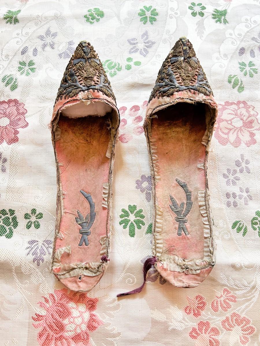Late 18th century, early 19th century
Ottoman Empire
A precious and very old pair of mules for the harem in the Ottoman Empire. Rigid curved shape covered with pink silk satin with a pointed instep. Rich embroidery with a silver blade Tughra with a