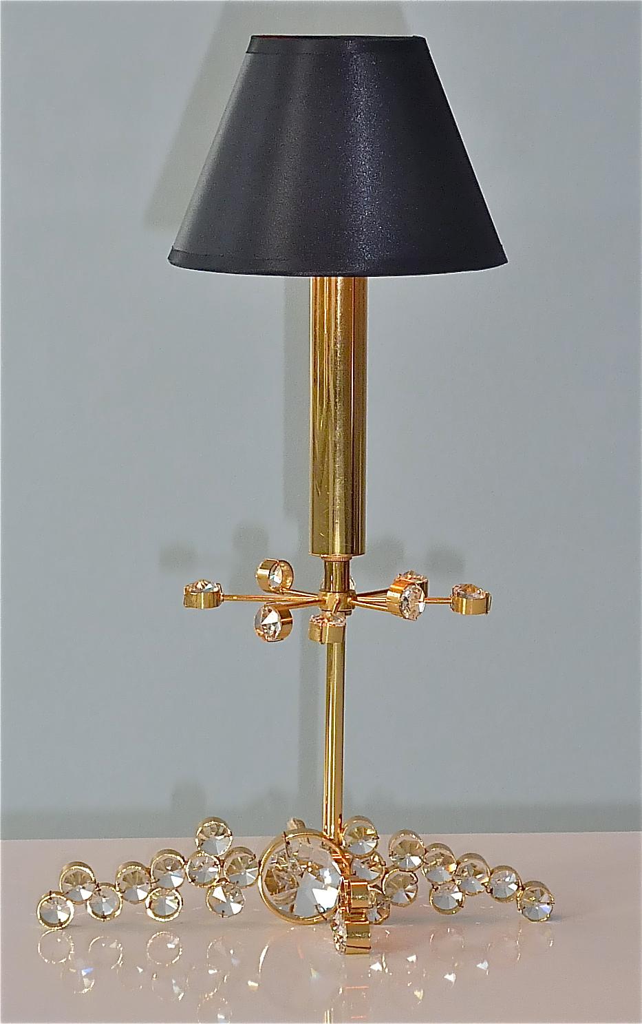 Rare and early precious midcentury table lamp designed and executed by Palwa, Germany around 1950s to 1960s. The table lamp has beautifully hand-cut and polished faceted octagonal crystal glass prisms which sparkle like diamonds, mounted on a