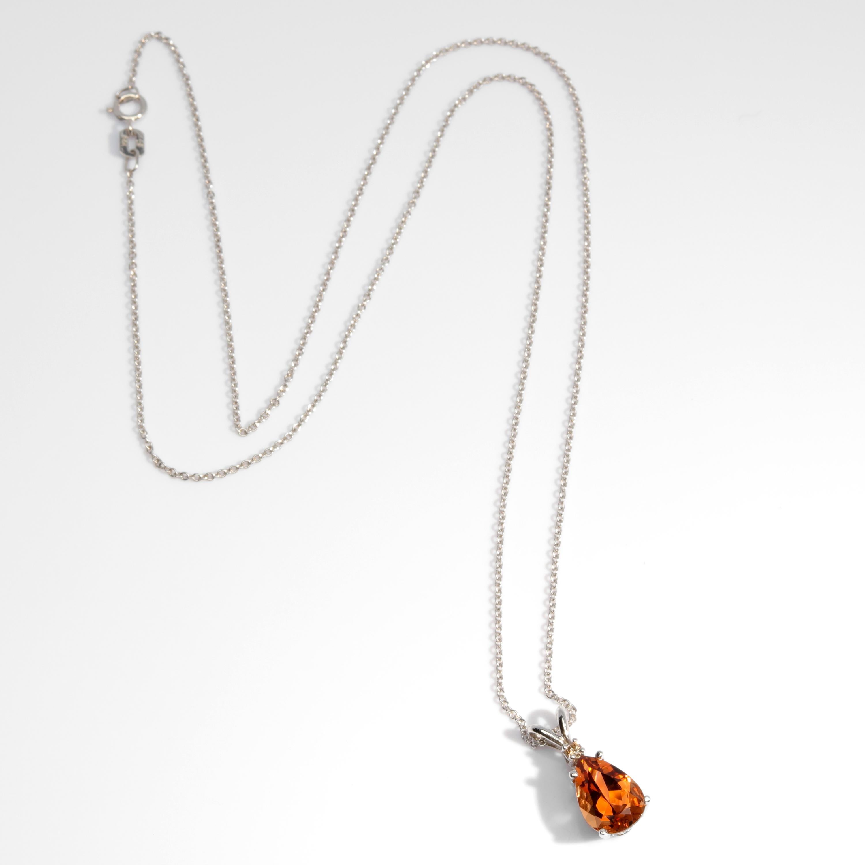 A pear-cut precious topaz the color of fine aged whiskey is crowned with a tiny brilliant diamond and suspended from a delicate white gold chain. The topaz is natural and measures approximately 10mm x 7.13mm and weighs just over 2-carats (2.14). 