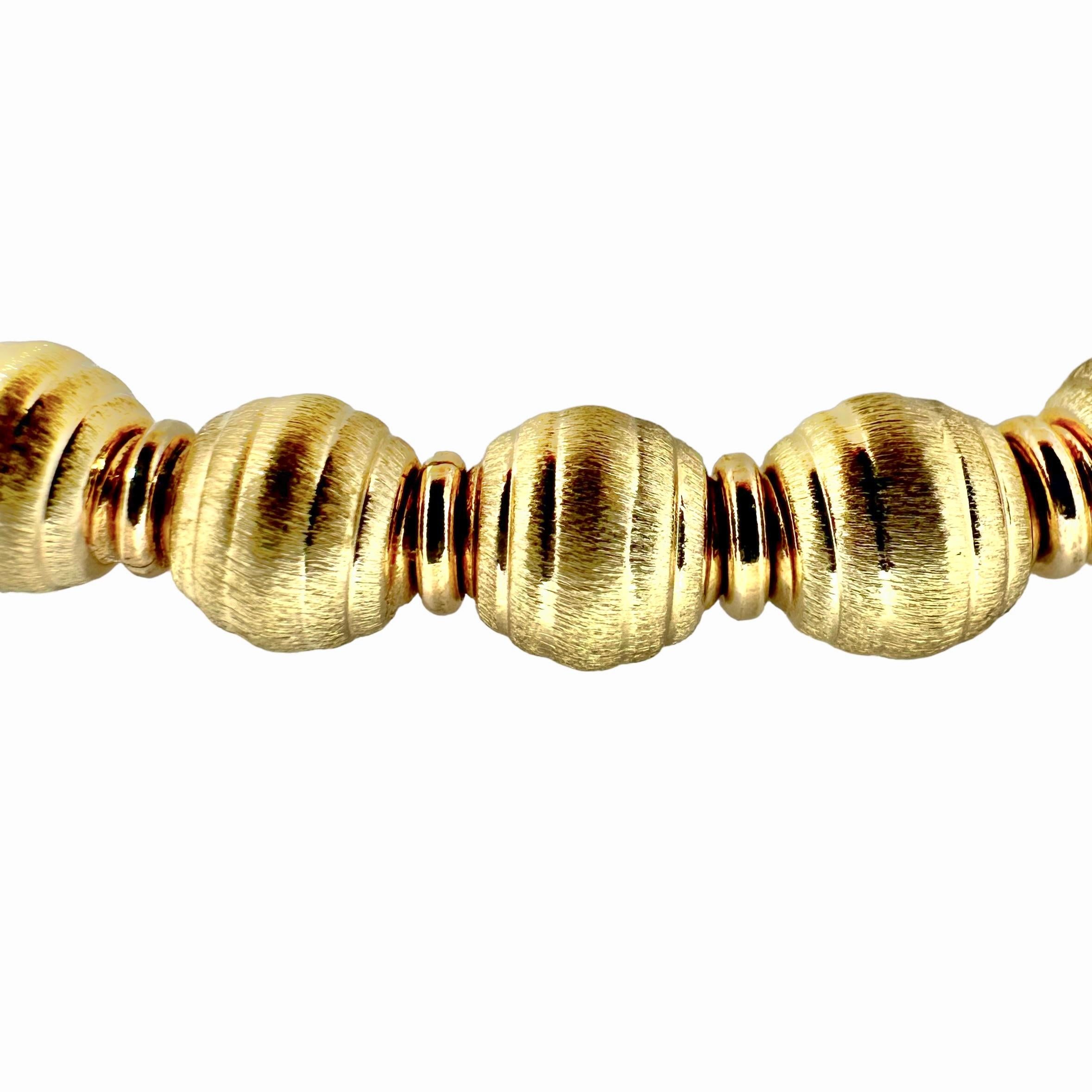 This Italian 14k yellow gold bead necklace is precision crafted with an extreme amount of detail lavished on each bead. A smart, tailored look that is ideal for casual wear or for office wear. Every 6mm bead is brush finish on the body and high