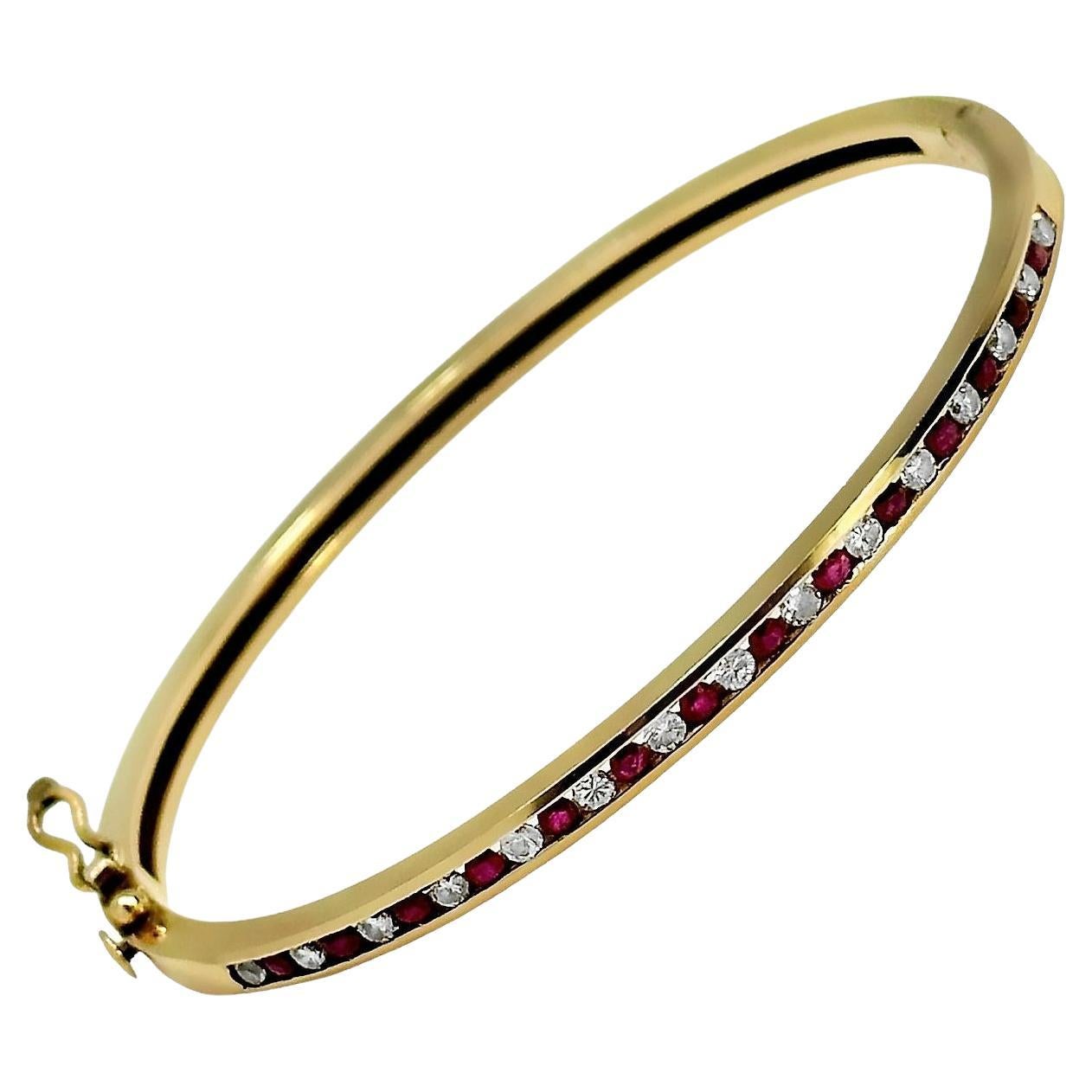 This expertly crafted late-20th Century hinged bangle bracelet is precision channel set with one straight line of alternating brilliant cut diamonds and bright red natural rubies. Total approximate diamond weight is .50ct and total approximate ruby