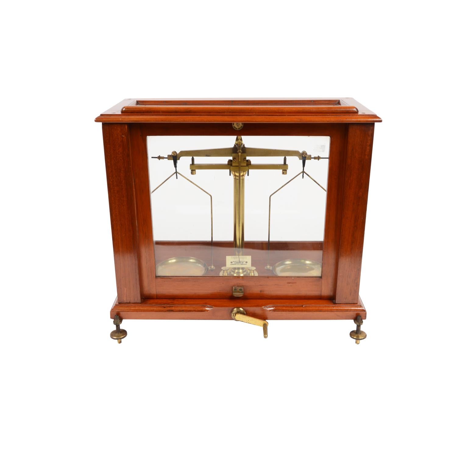 Precision pharmaceutical laboratory scale signed Baird & Tatlock BTL London England from 1910 for galenic preparations with brass weights from 1-2-5-10-20-50-100 grams, as well as numerous foil weights and tweezers, in the its box in mahogany wood.