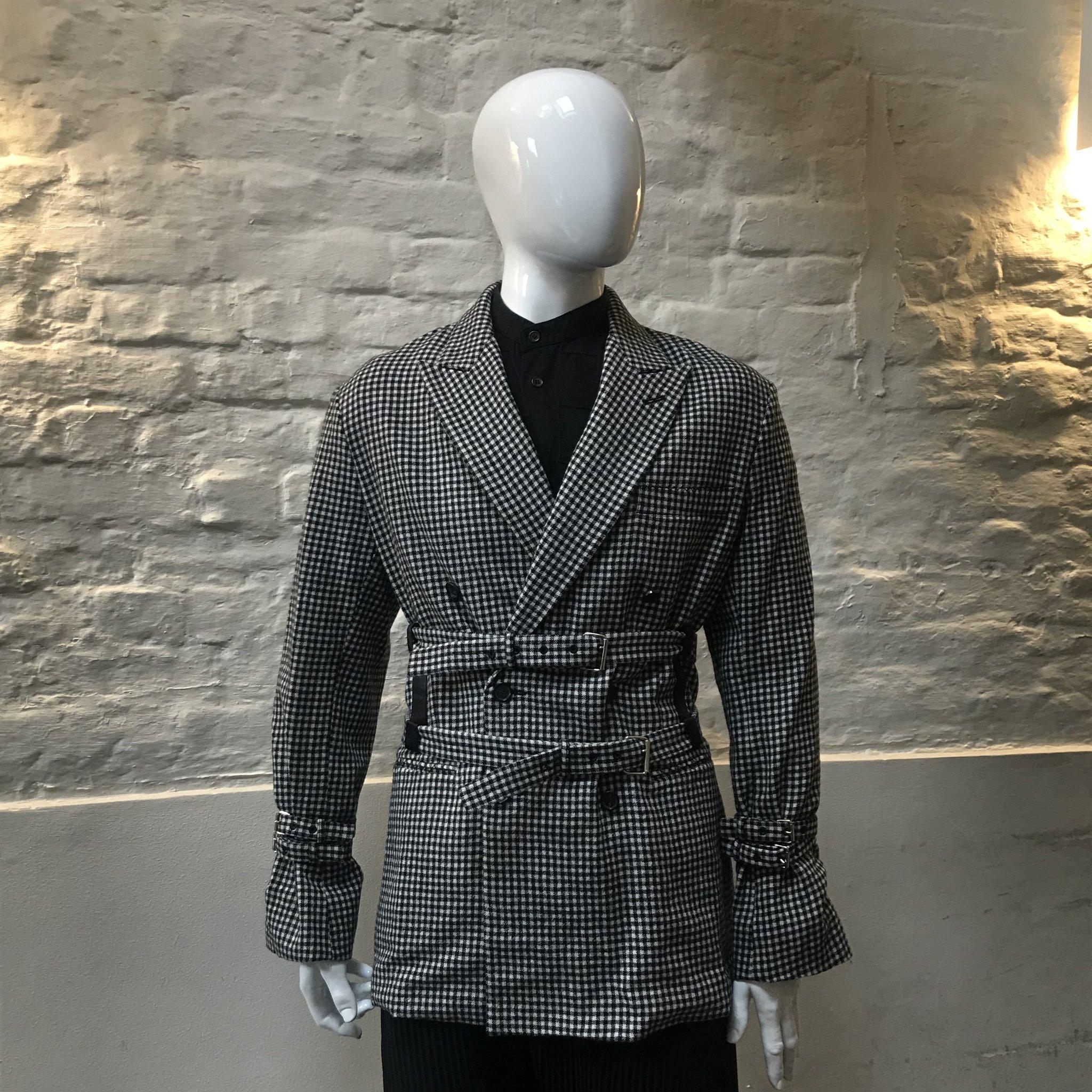 Preen by Thornton Bergazzi Dog Tooth Belt Jacket made in the UK from wool. 

Preen By Thornton Bregazzi was founded in 1996 by Justin Thornton and Thea Bregazzi, built on an aesthetic of darkly romantic and effortlessly modern, juxtaposing the