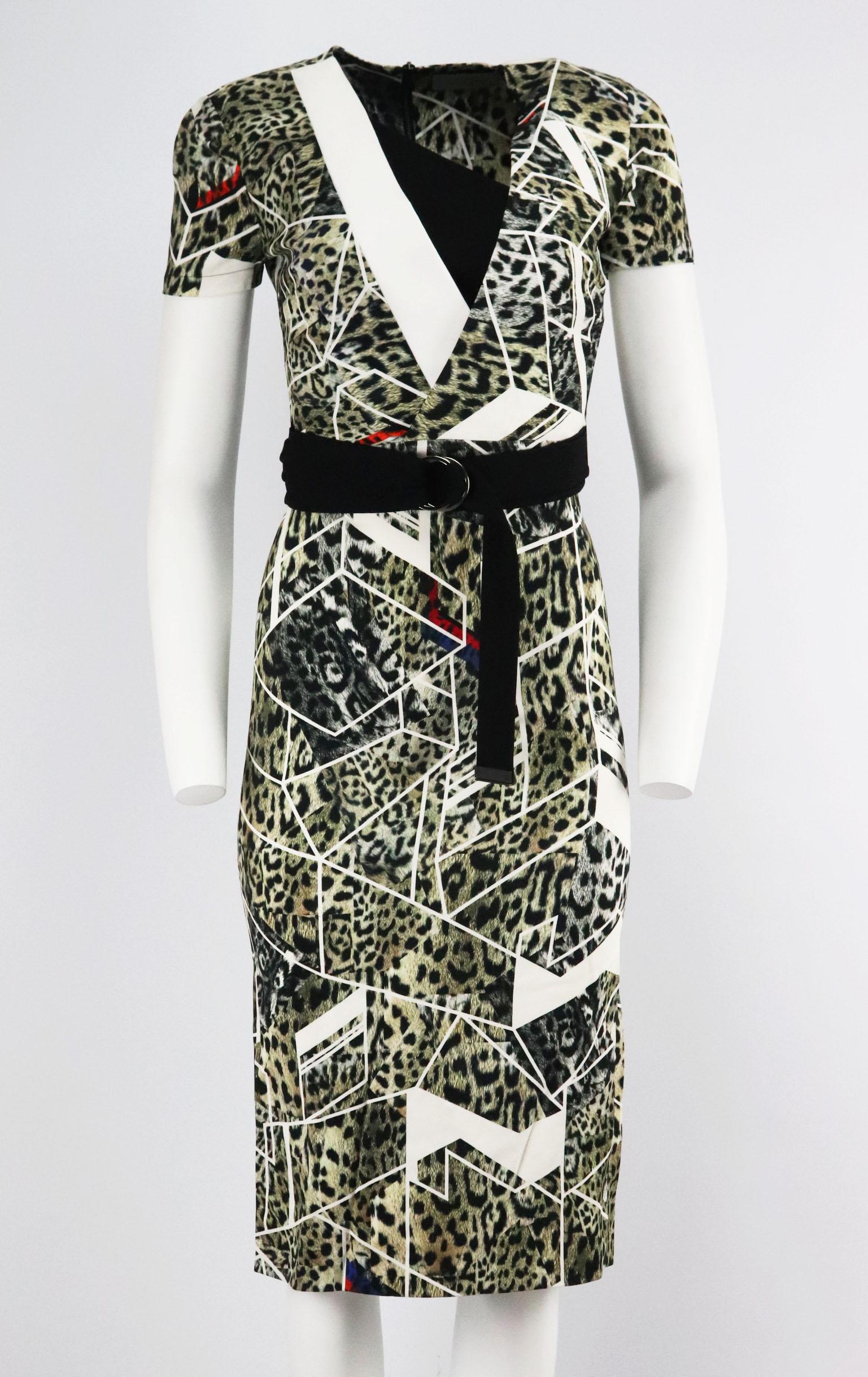 This dress by Preen by Thornton Bregazzi is made from jersey that's printed with a geometric and leopard design, it's cut in a wrap-effect silhouette, it's embellished with an D-shaped ring belt that emphasizes the waist and falls to hit just below