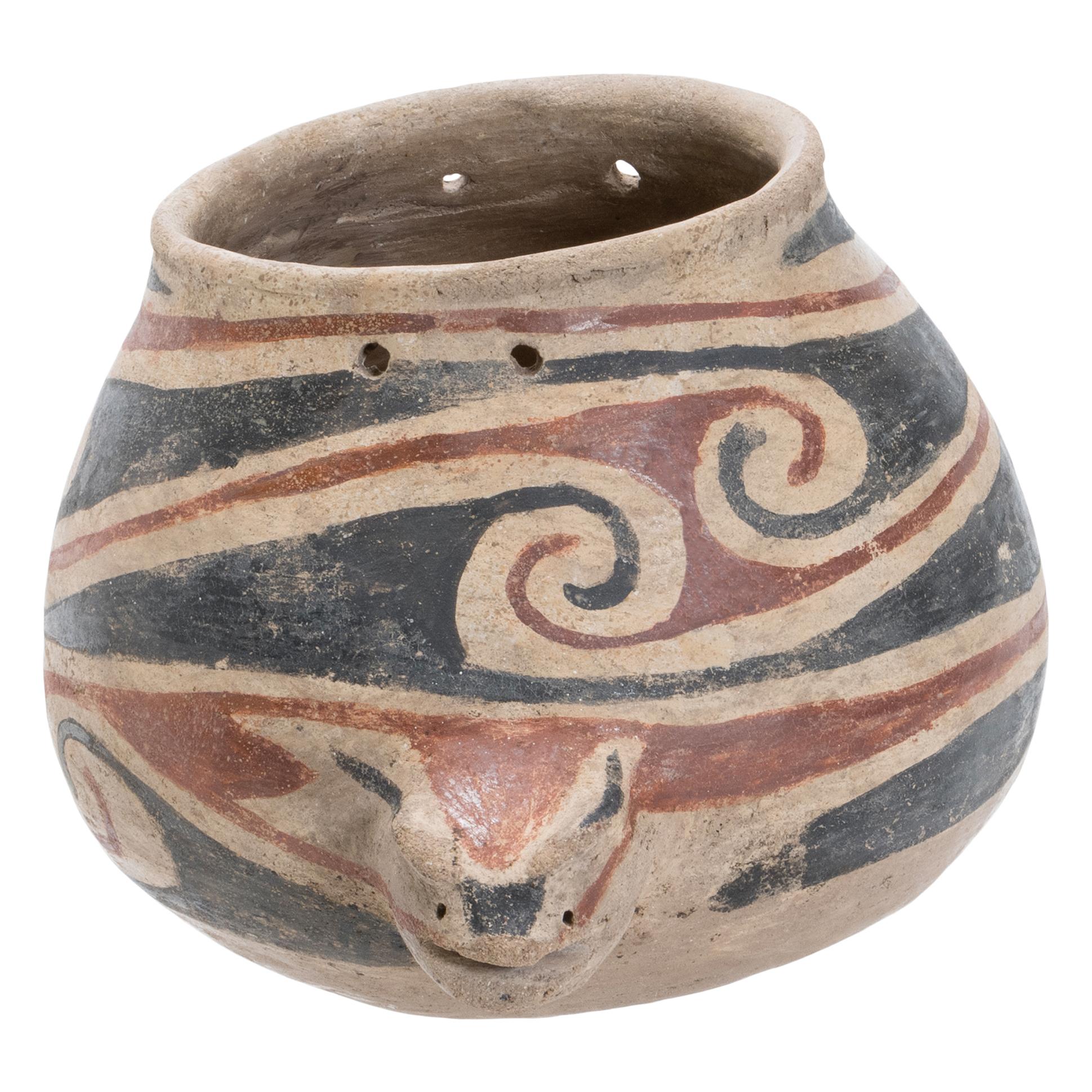 Pre-Columbian, Northern Mexico, Chihuahua, Mogollon culture, Casas Grandes or Paquime, ca. 1130 to 1450 CE. A charming pottery vessel in the form of a fish featuring a bulbous body with a lizard-like head projecting from one side and a bifurcated