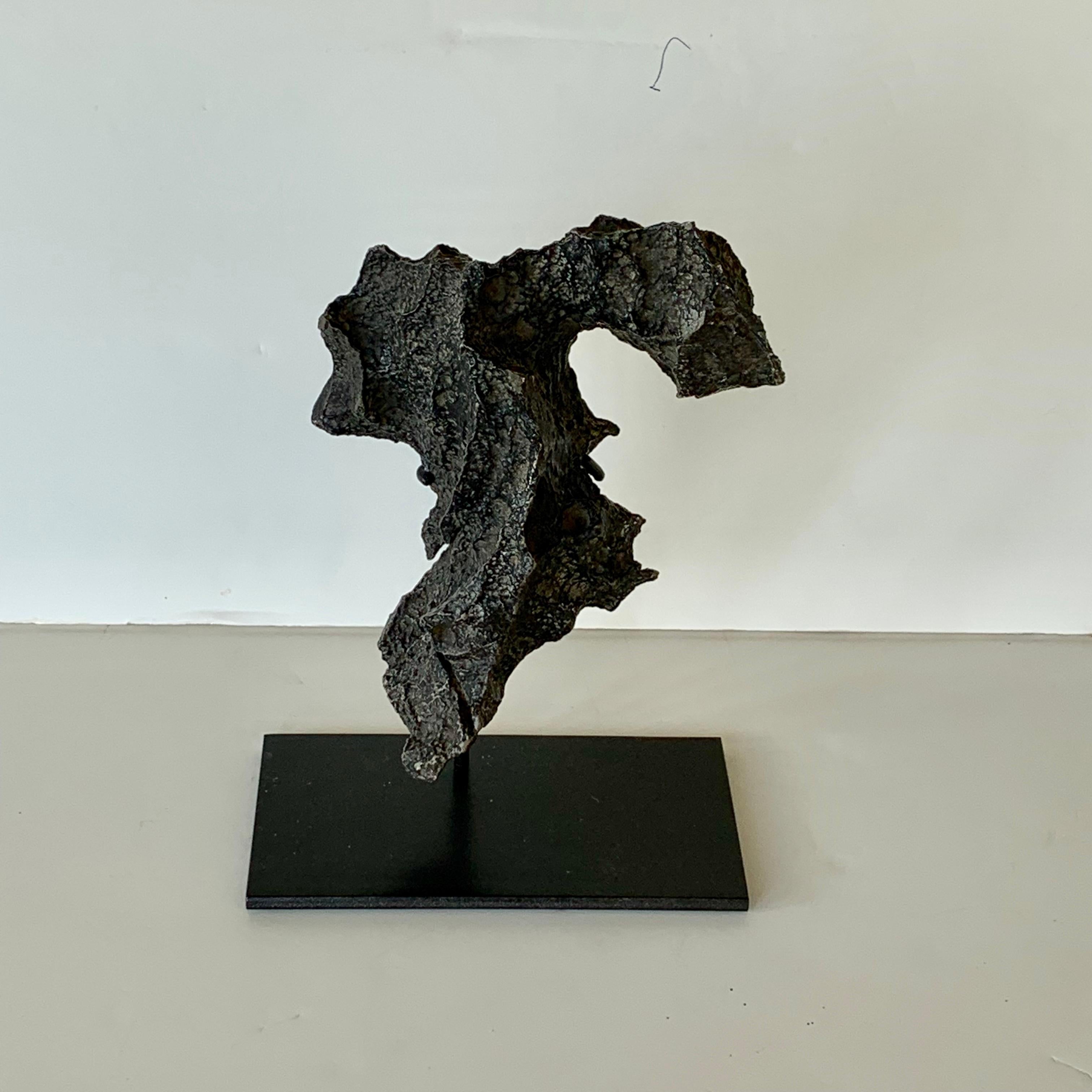 Prehistoric piece of vertical iron ore stone sculpture mounted on custom steel 
Stand measures 10
