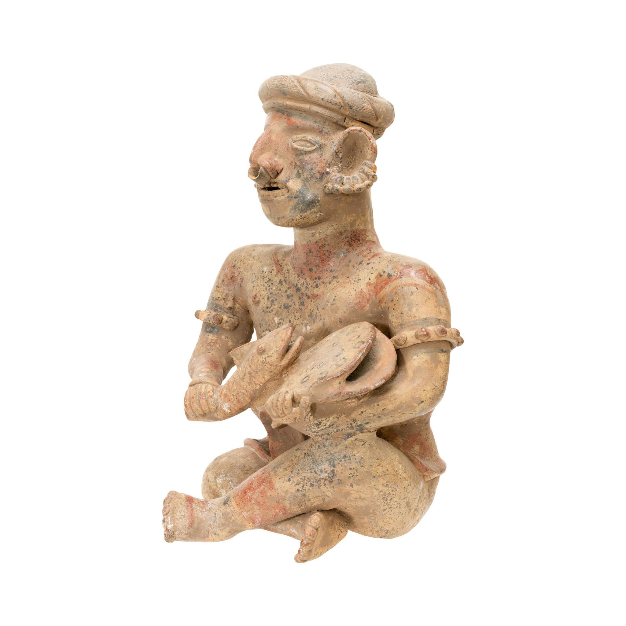Clay Prehistoric Majested Seated Drummer Figurine For Sale