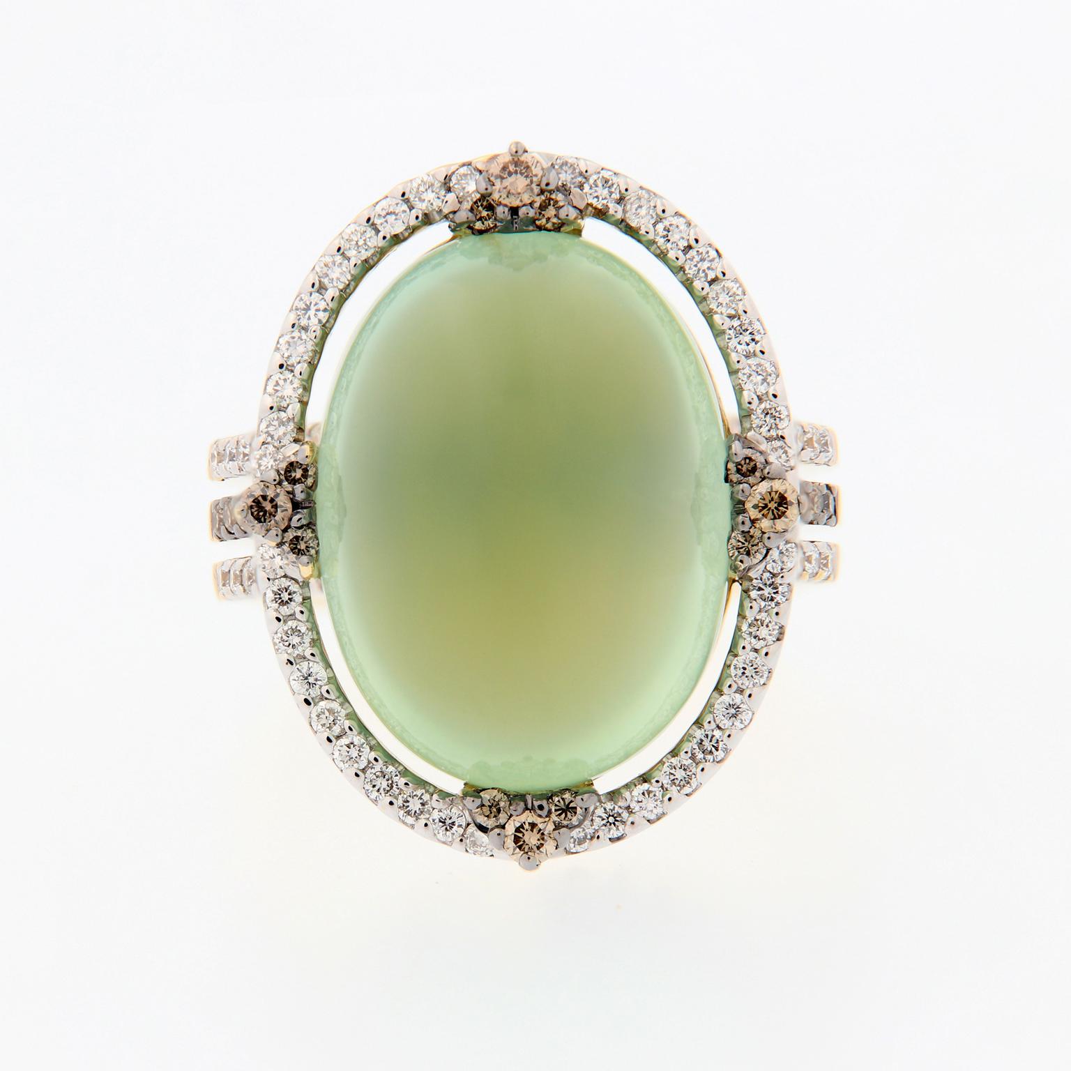 Prehnite is an intriguing gemstone that features a unique green glow. This ring centers around a 16.92 carat cabochon cut prehnite, accented with white and champagne colored diamonds. Ring size 6.5. Weighs 12.5 grams.

Prehnite 16.92 ct
Diamonds