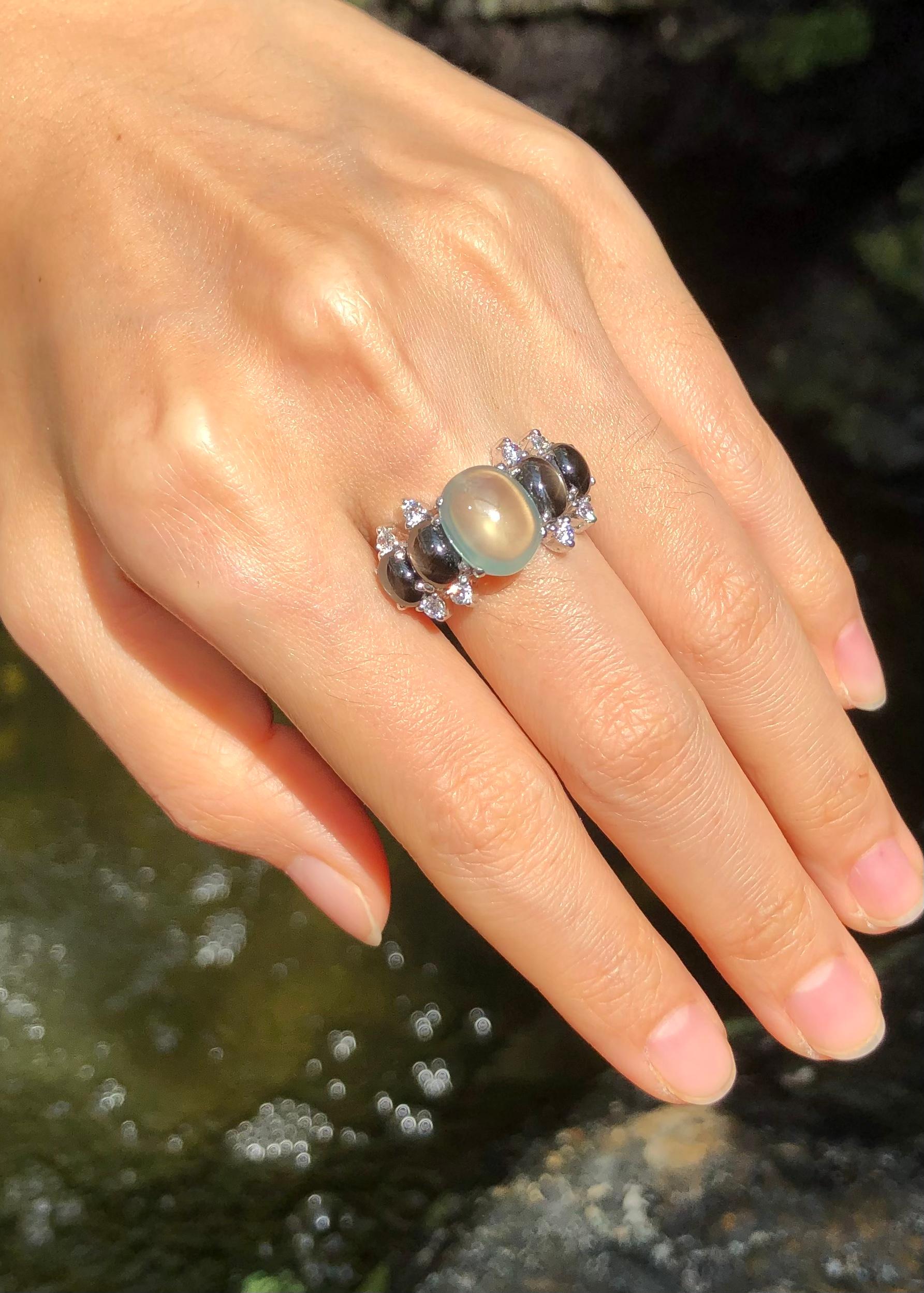 Prehnite, Black Star Sapphire and Cubic Zirconia Ring set in Silver Settings

Width:  2.3 cm 
Length: 1.2 cm
Ring Size: 57
Total Weight: 7.53 grams

*Please note that the silver setting is plated with rhodium to promote shine and help prevent