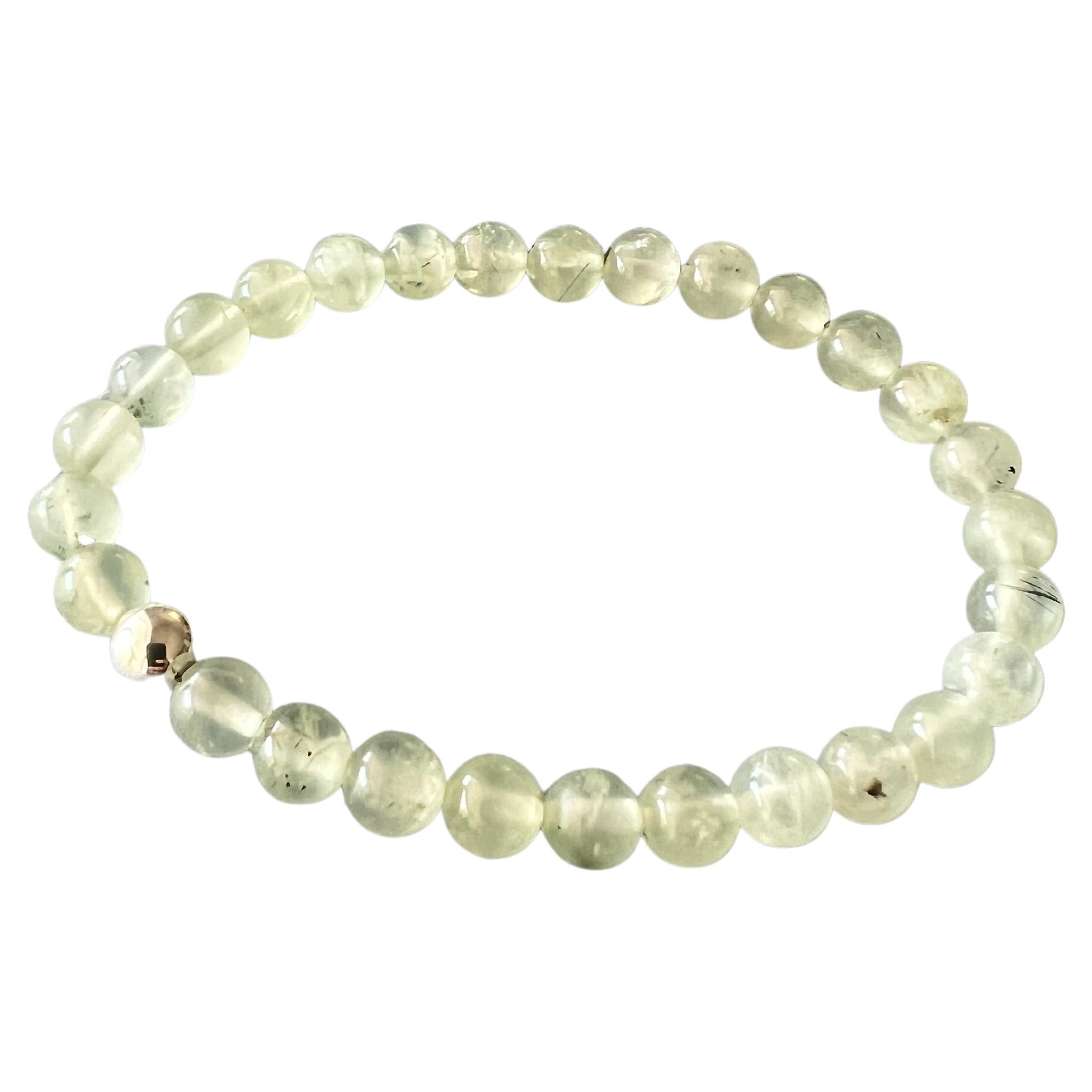 Green Prehnite Round Bead Stackable Elastic Bracelet with Silver Bead 

All Beads are the same size.

Made in Los Angeles

Designer: J Dauphin

The Prehnite Round Bead Bracelet is a blend of natural beauty and potent symbolism, rooted in the