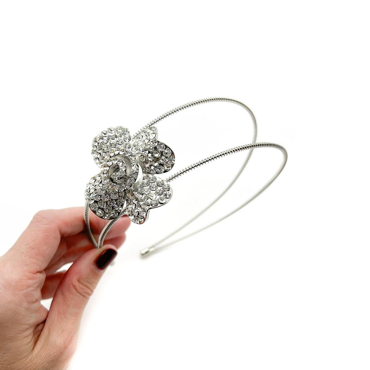 A Crystal Flower Tiara. A simple double head band adorned with a large crystal set flower.
An unsigned beauty. Just because a jewel doesn’t carry a designer name, doesn’t mean it isn't coveted. The unsigned beauties in our collection are sourced