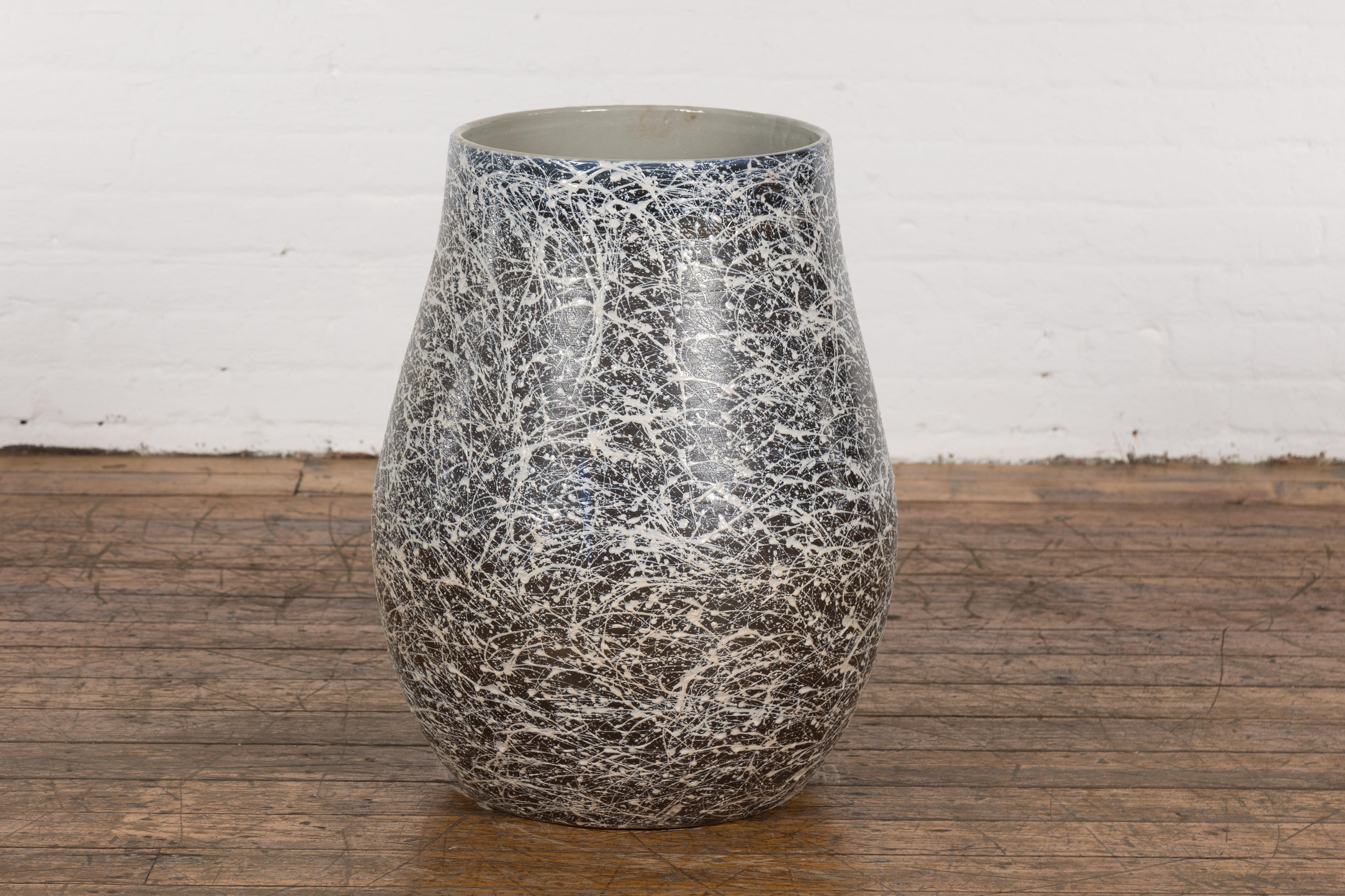 An artisan Prem Collection ceramic planter with nice rounded shape, black ground, white and grey blue splatter and grey glazed interior. Charming our eyes with its graceful lines, nice proportions and stylish décor, this planter is hand-crafted from