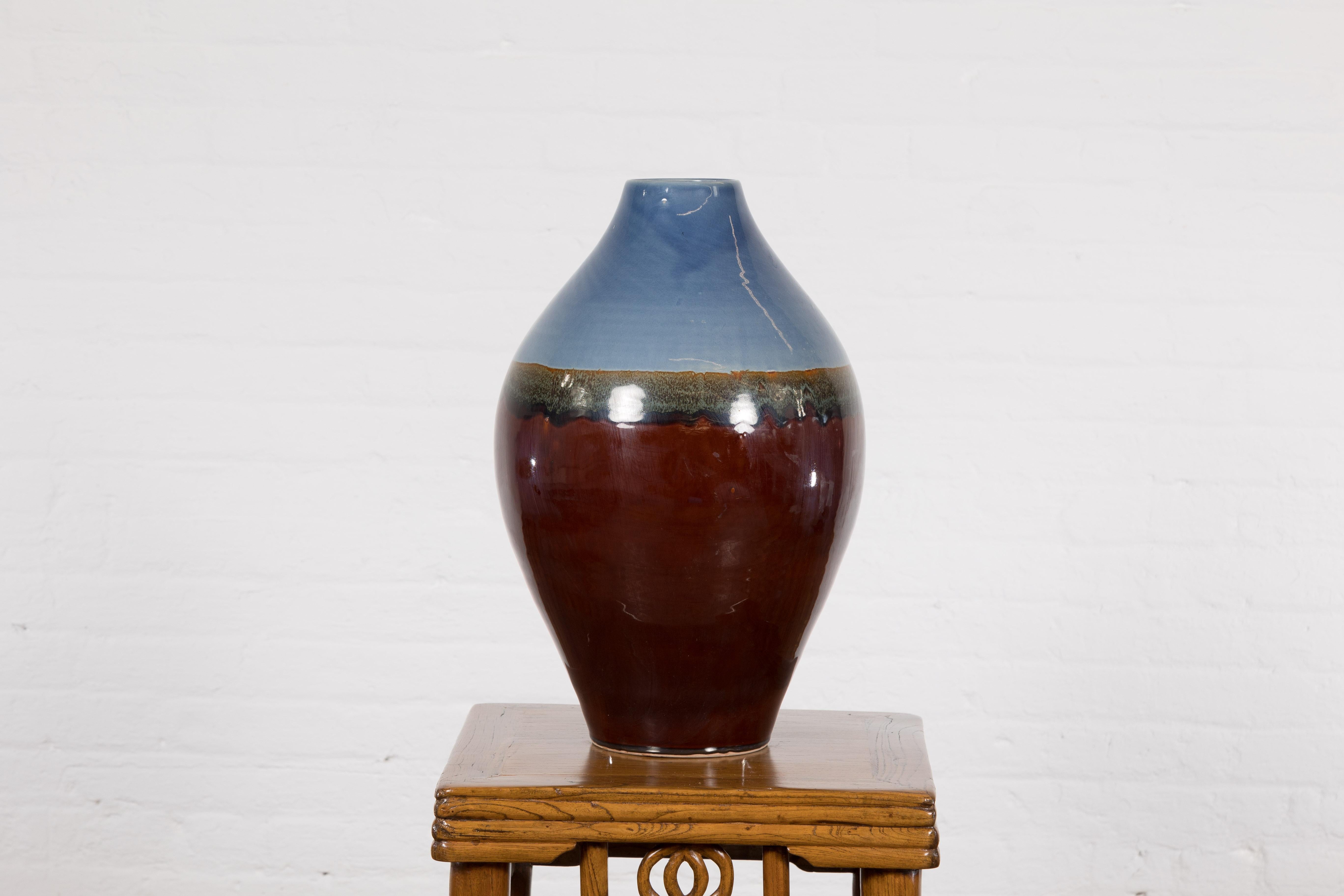Contemporary Prem Collection ceramic vase with blue and reddish brown colors. Introducing an exquisite piece from the Prem Collection, this ceramic vase is an alchemy of colors and form, blending blue and reddish-brown hues to create an eye-catching