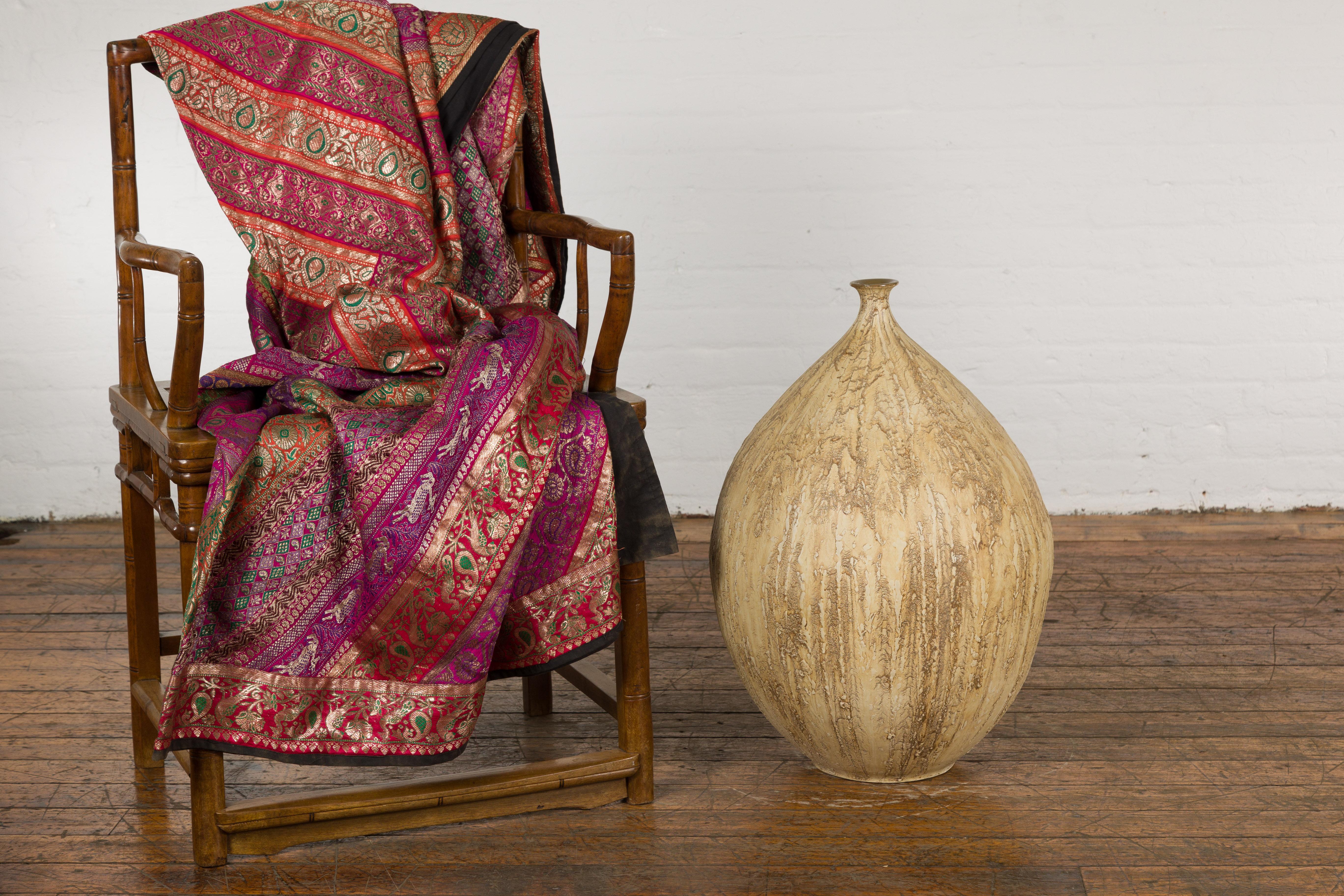 A contemporary Prem Collection artisan hand crafted ceramic vase with narrow mouth, mustard glaze and textured effects. Showcasing elegant lines, this hand crafted Prem Collection artisan ceramic vase features a mustard glaze beautifully enlivened