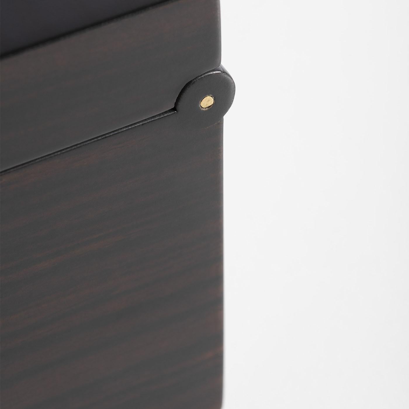 A precious keepsake, this exceptional jewelry box will safeguard prized jewels and add an elegant touch to a bedroom or vanity decor. Fashioned of ebony, the lid opens to reveal multiple compartments and drawers to store rings, necklaces, and your