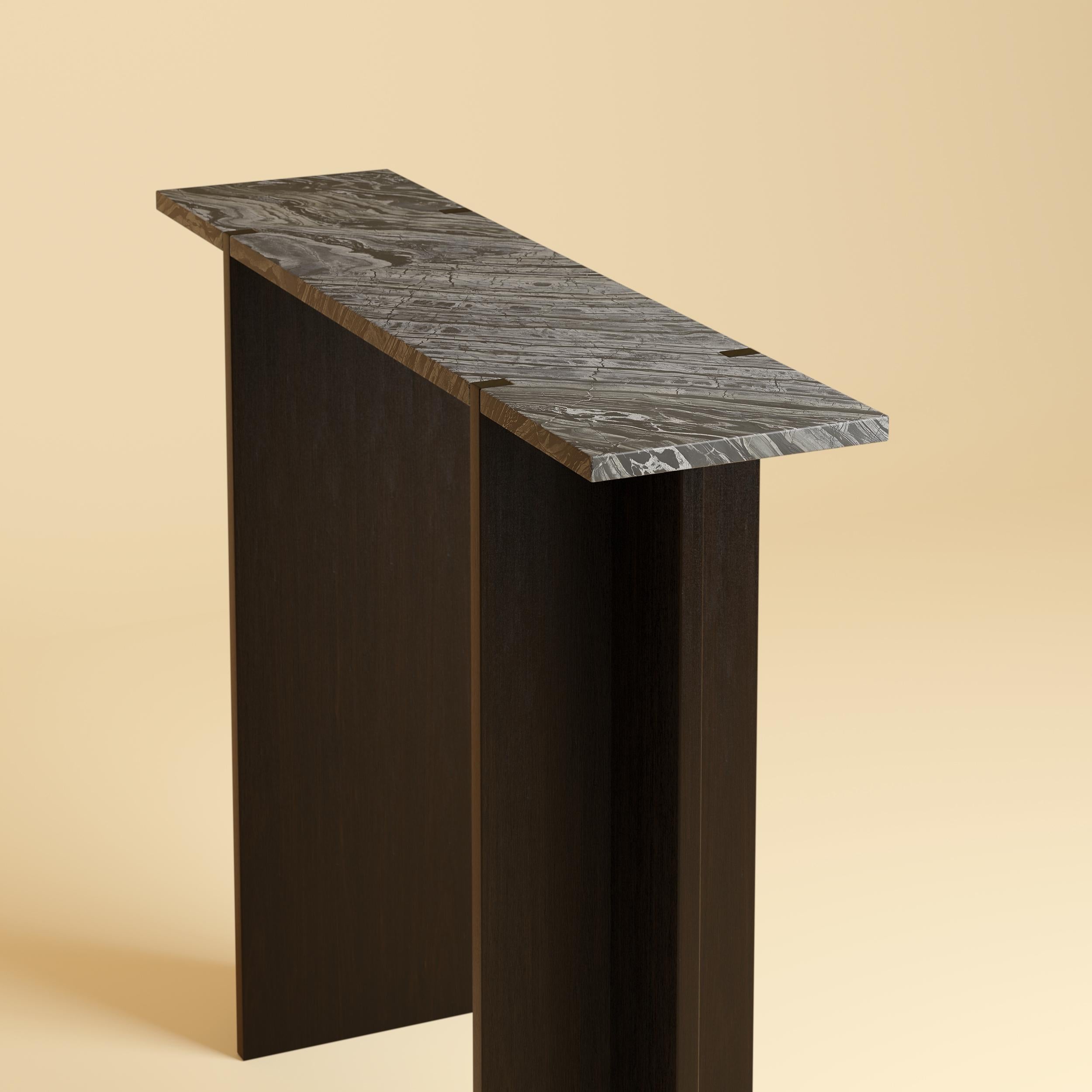 The Maha Console Table by Lebanto is a stunning blend of natural materials and expert craftsmanship, designed to bring timeless elegance to your home. Featuring a luxurious marble or travertine tabletop and solid oak legs, this console table is a